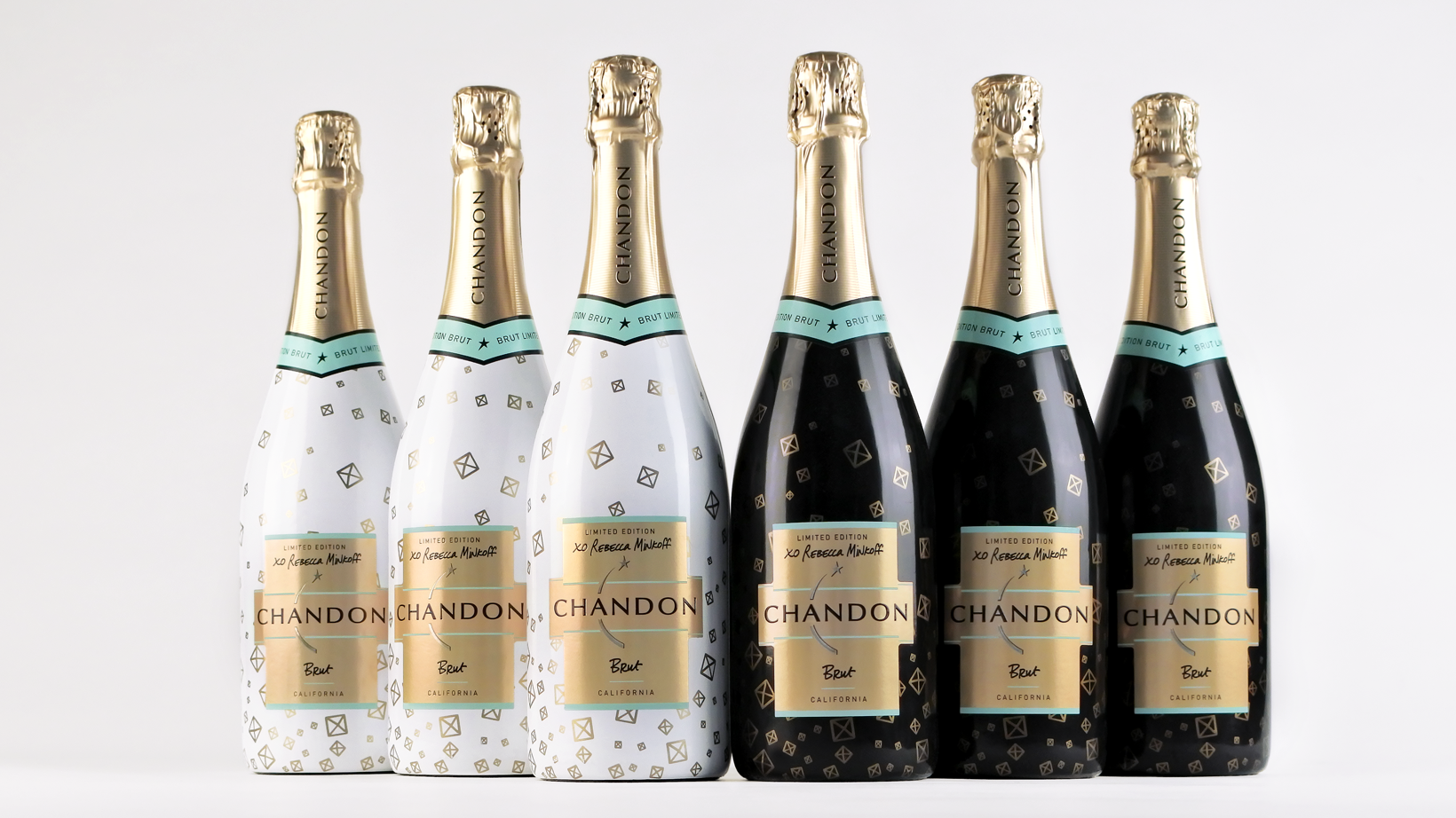 Six Chandon × Rebecca Minkoff bottles in white and black, with gold geometric patterns and metallic labels.