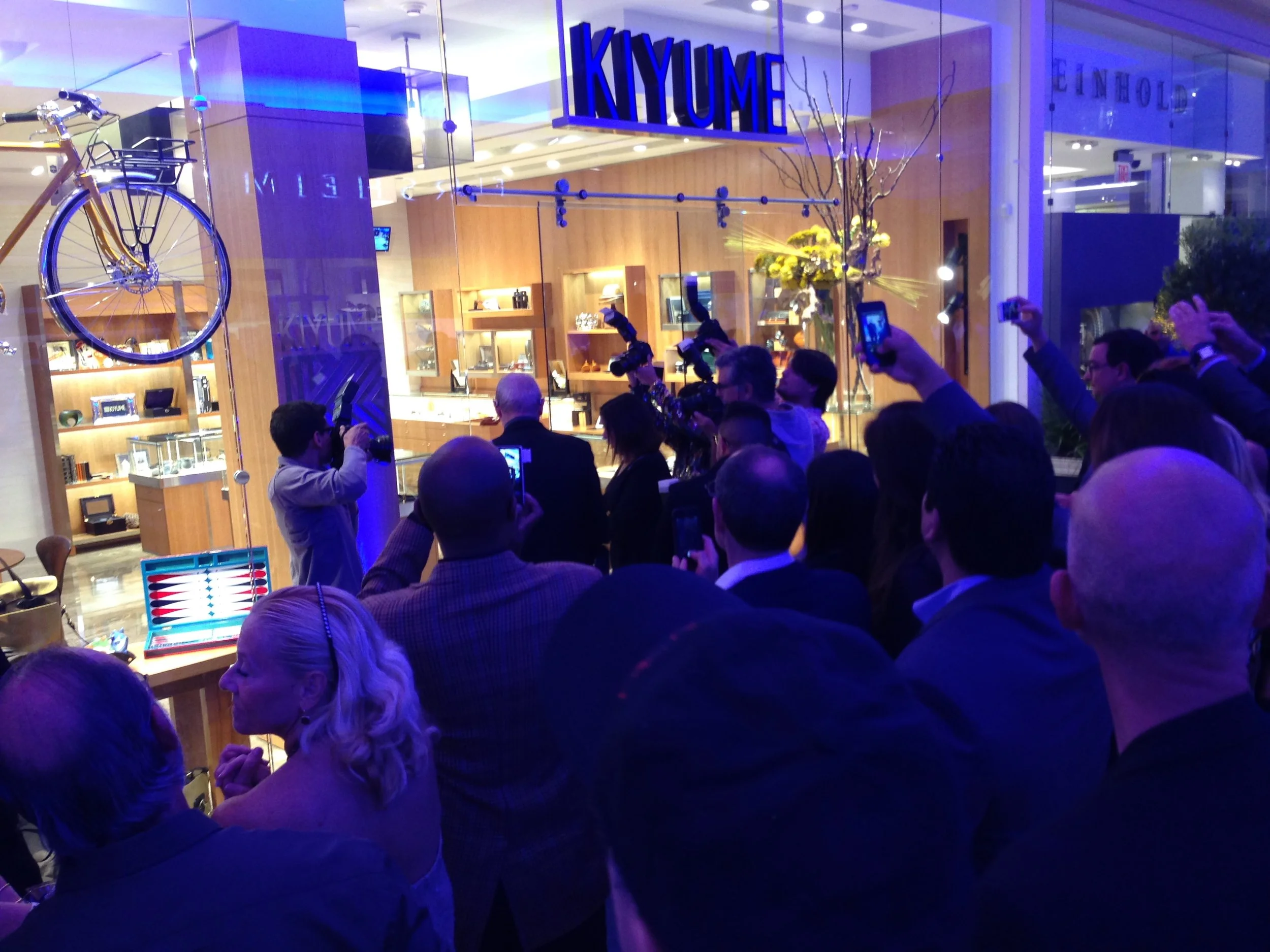 Guests photographing the illuminated Kiyume storefront during the retail launch event.