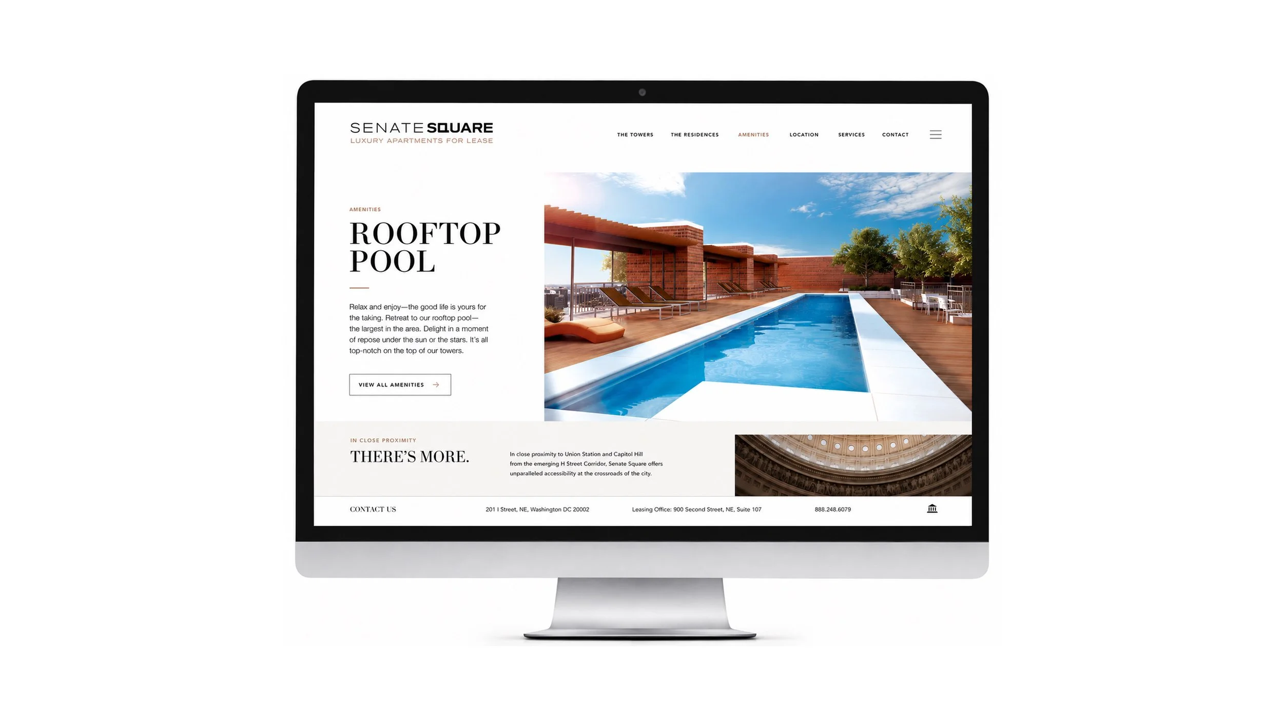 Senate Square amenities webpage on a desktop monitor, featuring the rooftop pool and a link to view all amenities.