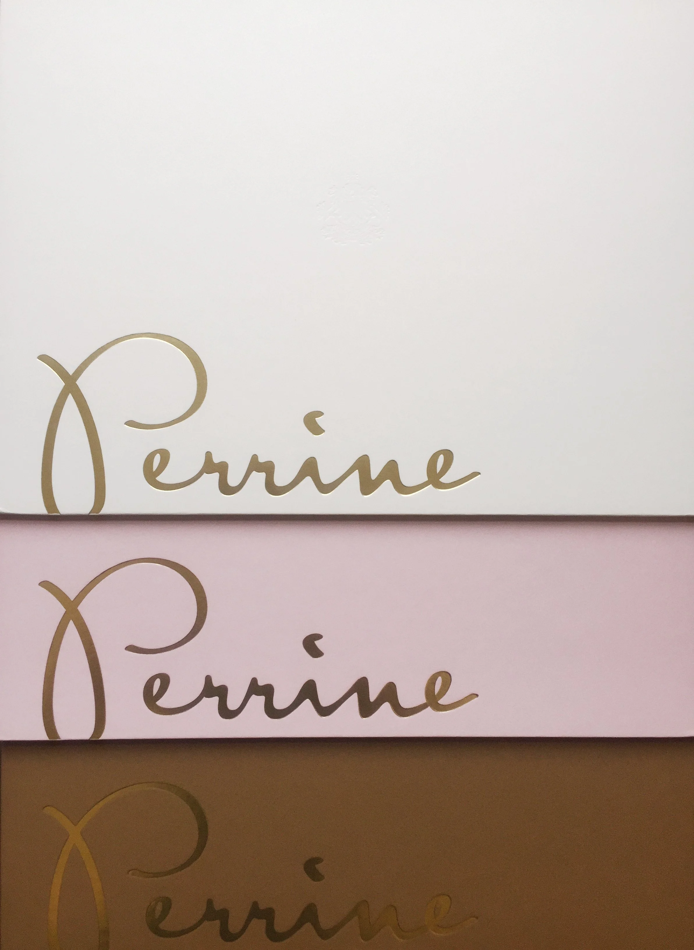 Perrine menu covers in cream, pale pink and brown with oversized gold signature lettering.
