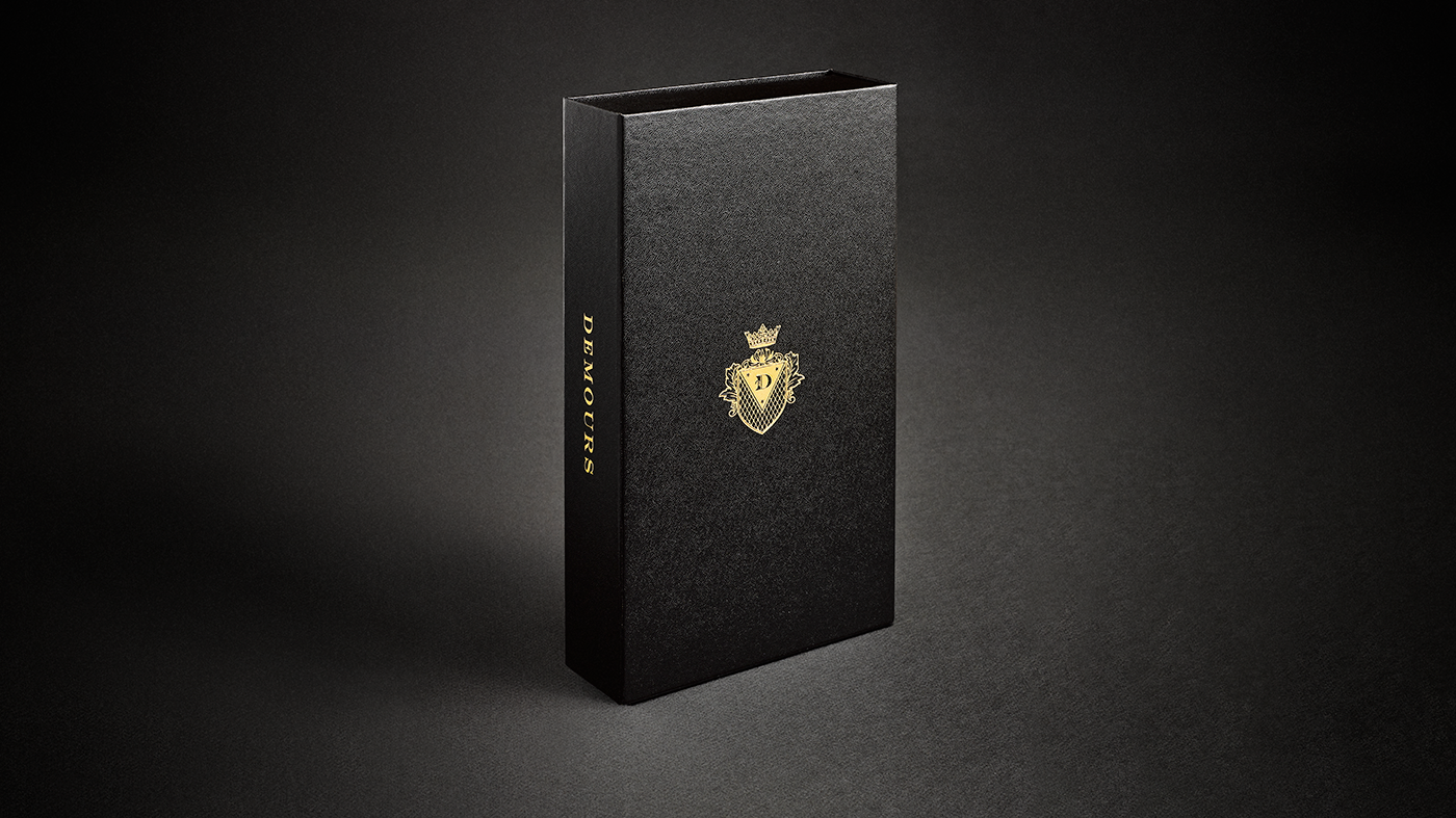 Black Demours Coffee gift box with a gold crest and wordmark.
