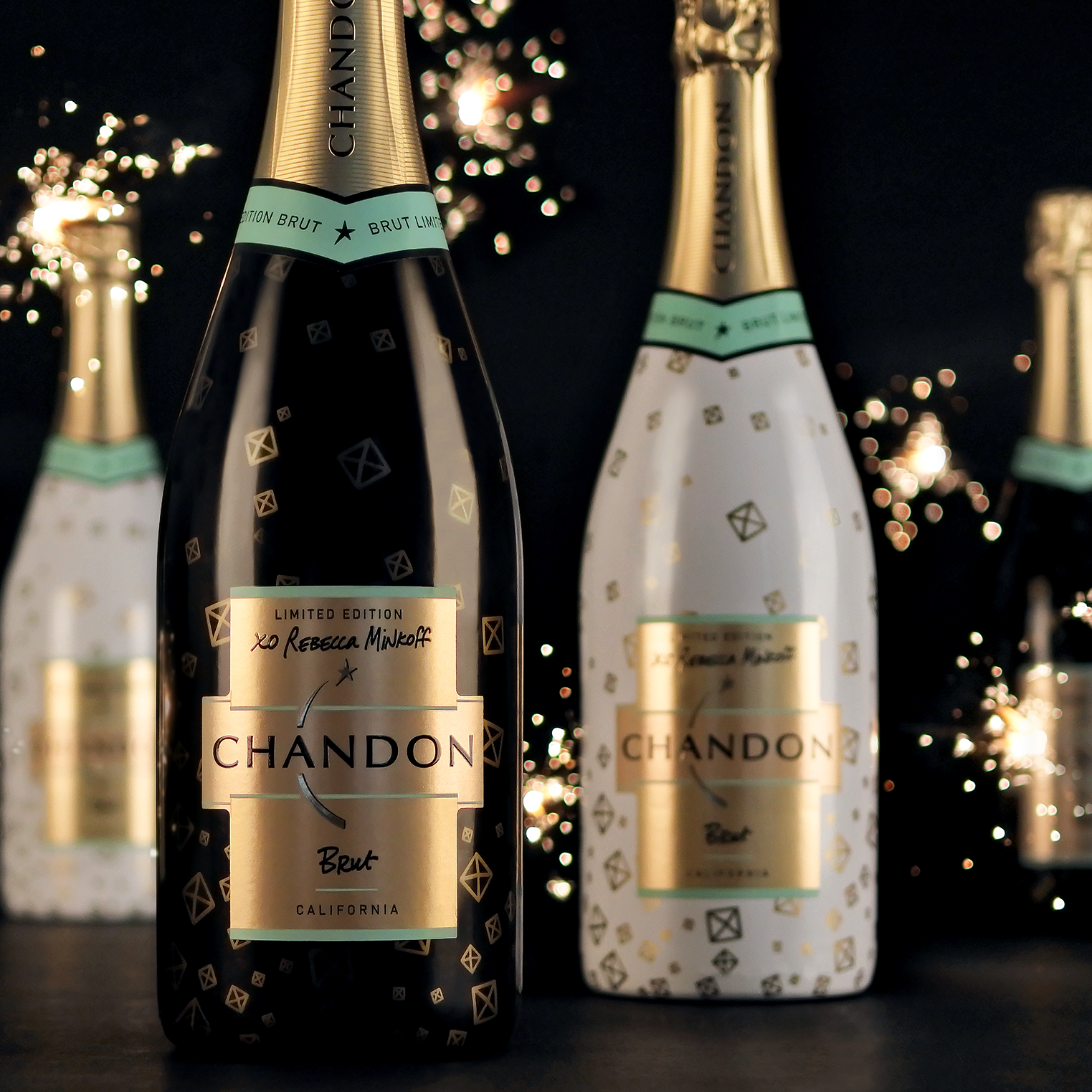 Close-up of the gold Chandon × Rebecca Minkoff label on a white patterned bottle.