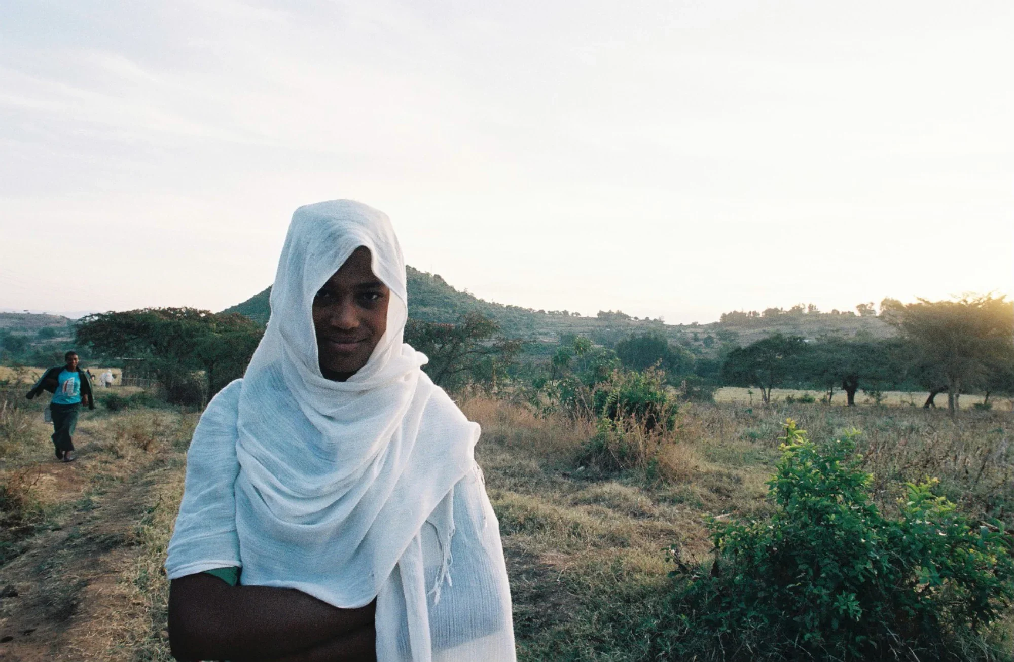 A young Ethiopian girl walking at dawn to school in the egalitarian community of Awra Amba. Founded in 1980 by Zumra Nuru, the community is home to over 450 residents and promotes gender equality. It remains controversial within religious communities