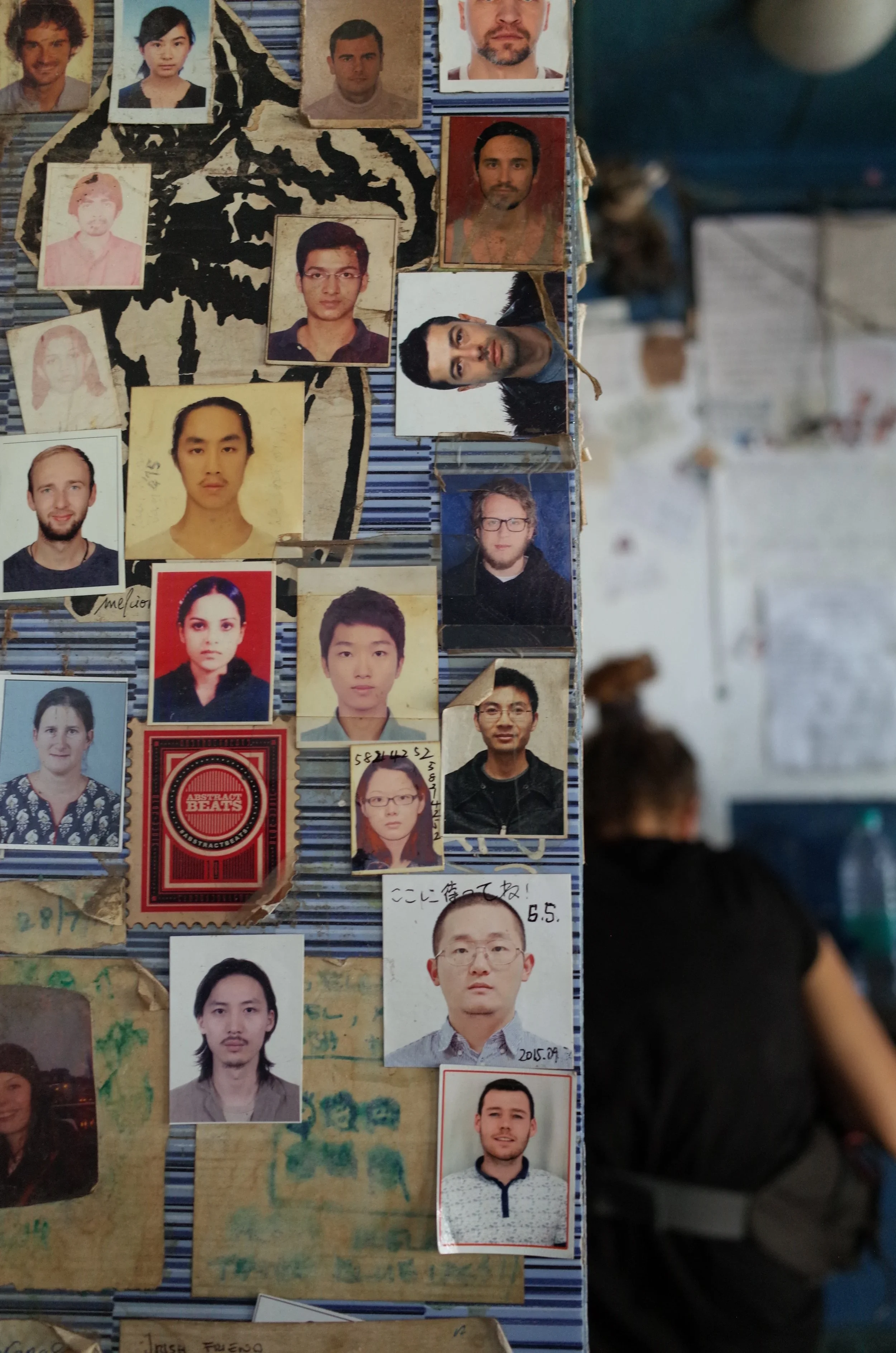 Tourists leave behind passport photos inside a popular Lassi shop in Varanasi, India.