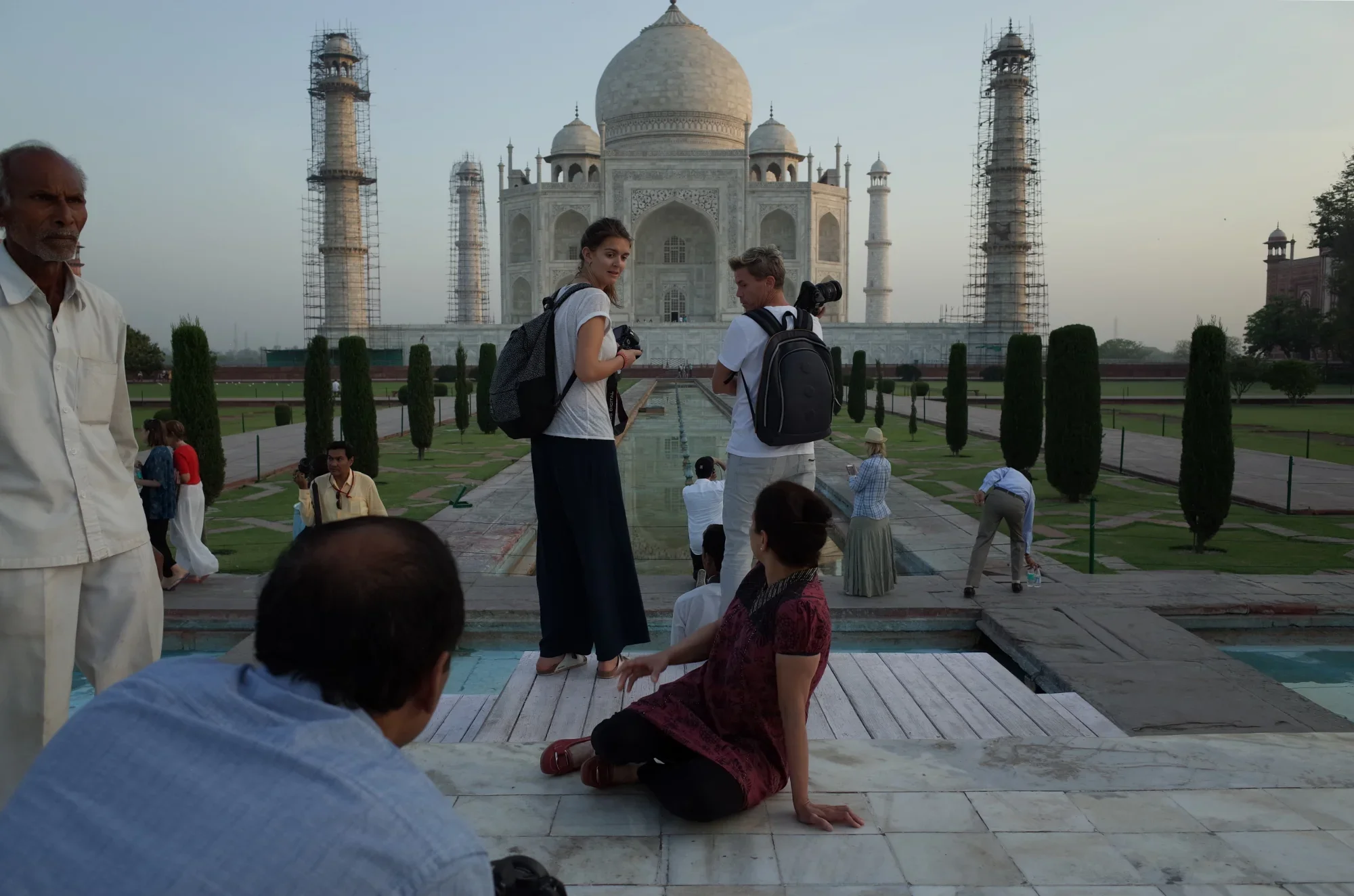 Exchanging frustrated glances, tourists hustle for the best spot to photograph the Taj Mahal at sunrise.