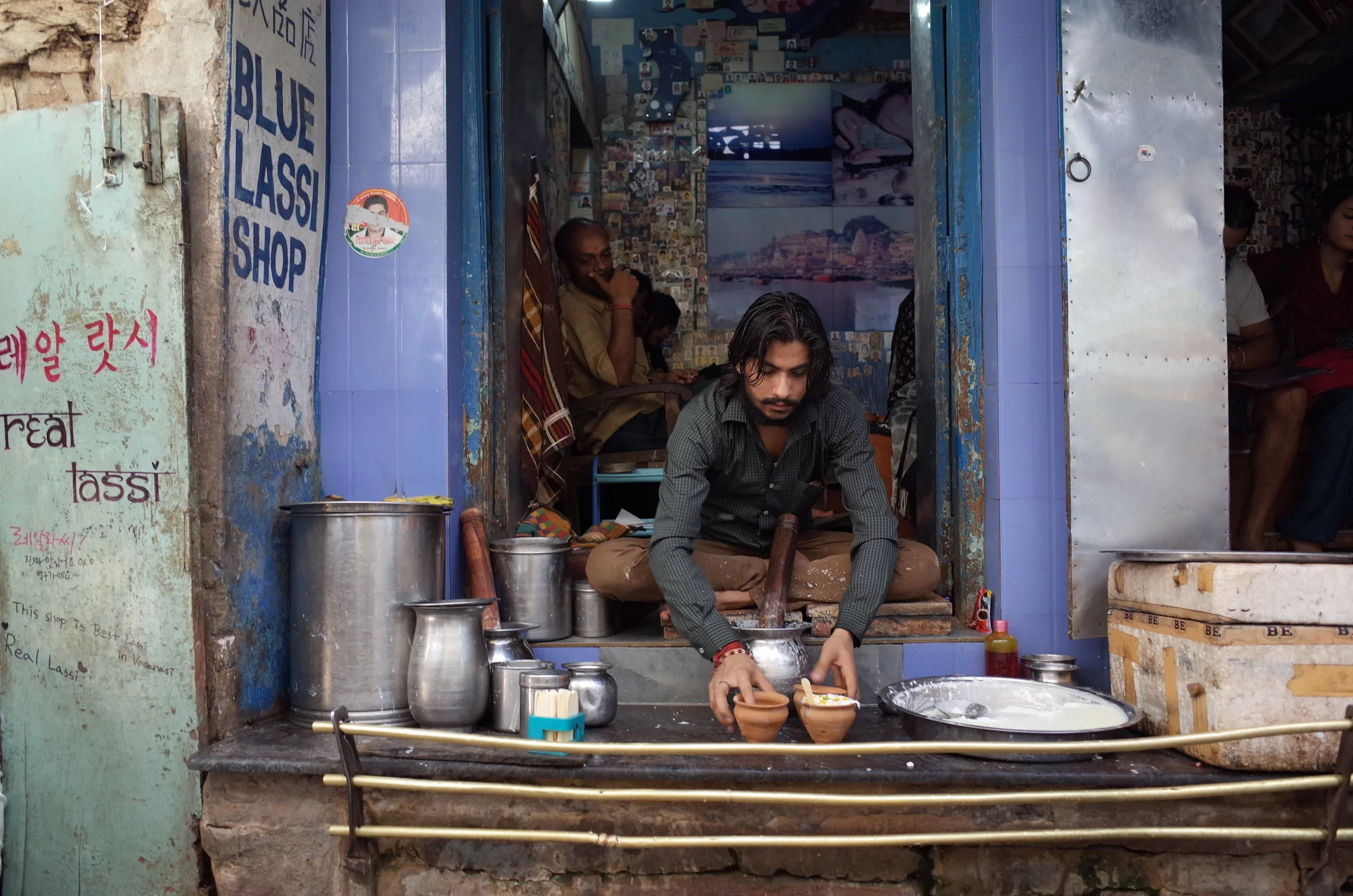 A man makes a pomegranate Lassi at the popular Blue Lassi Shop in Varanasi, India.