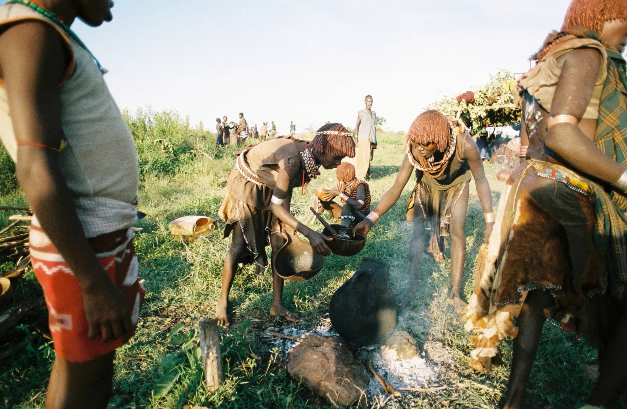 Women of the Hamar tribe prepare food in celebration of a traditional manhood ceremony.