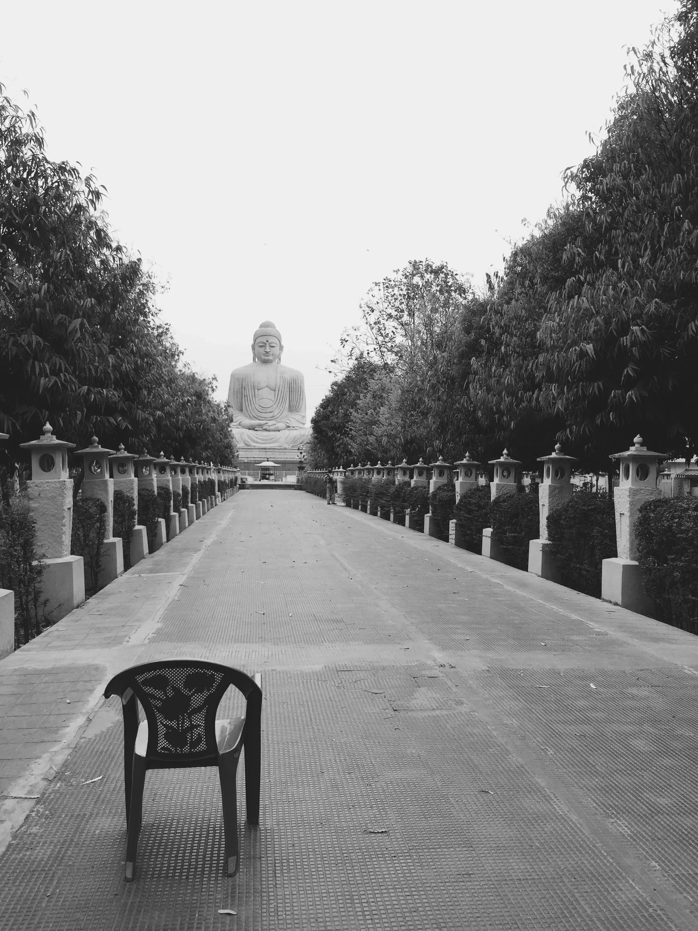 An empty chair at the end of a long path that leads to Buddha in Bodghaya, India. "Gaya" as it's known to locals, is where Buddha attainted enlightenment under the Bodhi tree.