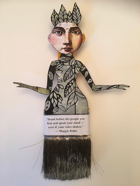 Mixed media art piece featuring a human face with a crown-like headdress, and a body made of leaf-patterned paper with outstretched arms, a quote by Maggie Kuhn, and long black hair at the bottom.