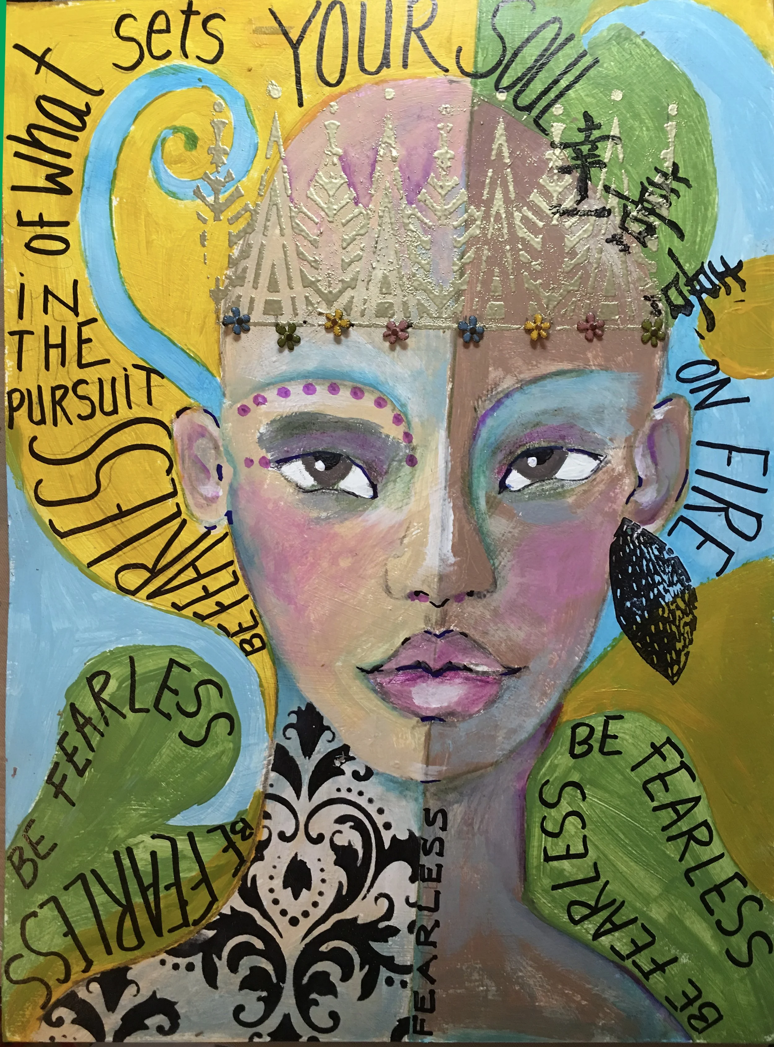 A colorful artwork featuring a woman's face with intricate makeup and adornments. The background is vibrant with yellow, green, blue, and pink colors. Handwritten phrases cover the image, including 'sets YOUR SELF' at the top, 'in the pursuit' on the left, and other inspirational words like 'fearless,' 'believe,' and 'be free.' There are decorative elements like small flowers and a black and white ornate pattern at the bottom.