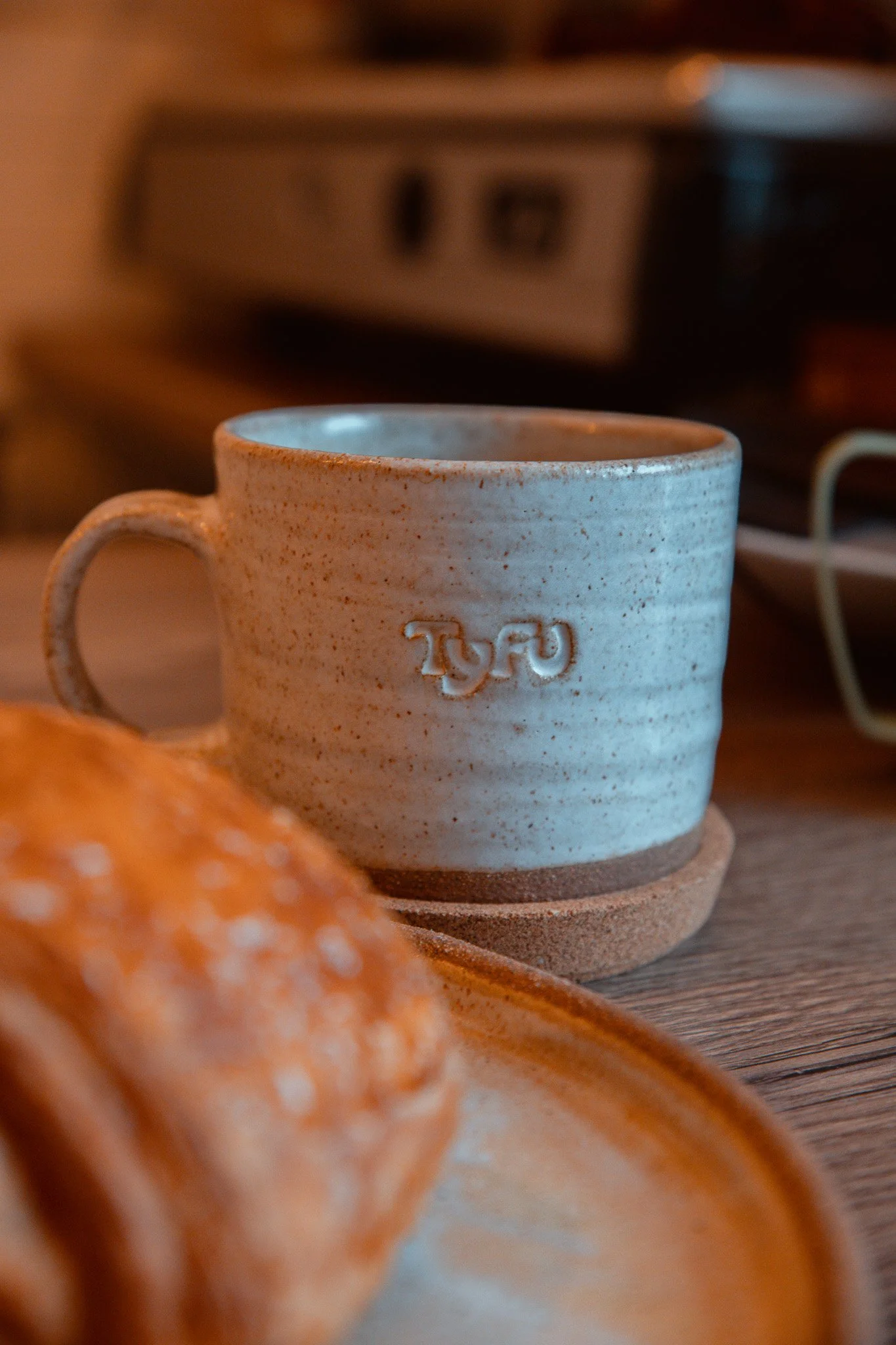 One of our custom Matt Jones Ceramics Tyfu branded coffee mugs