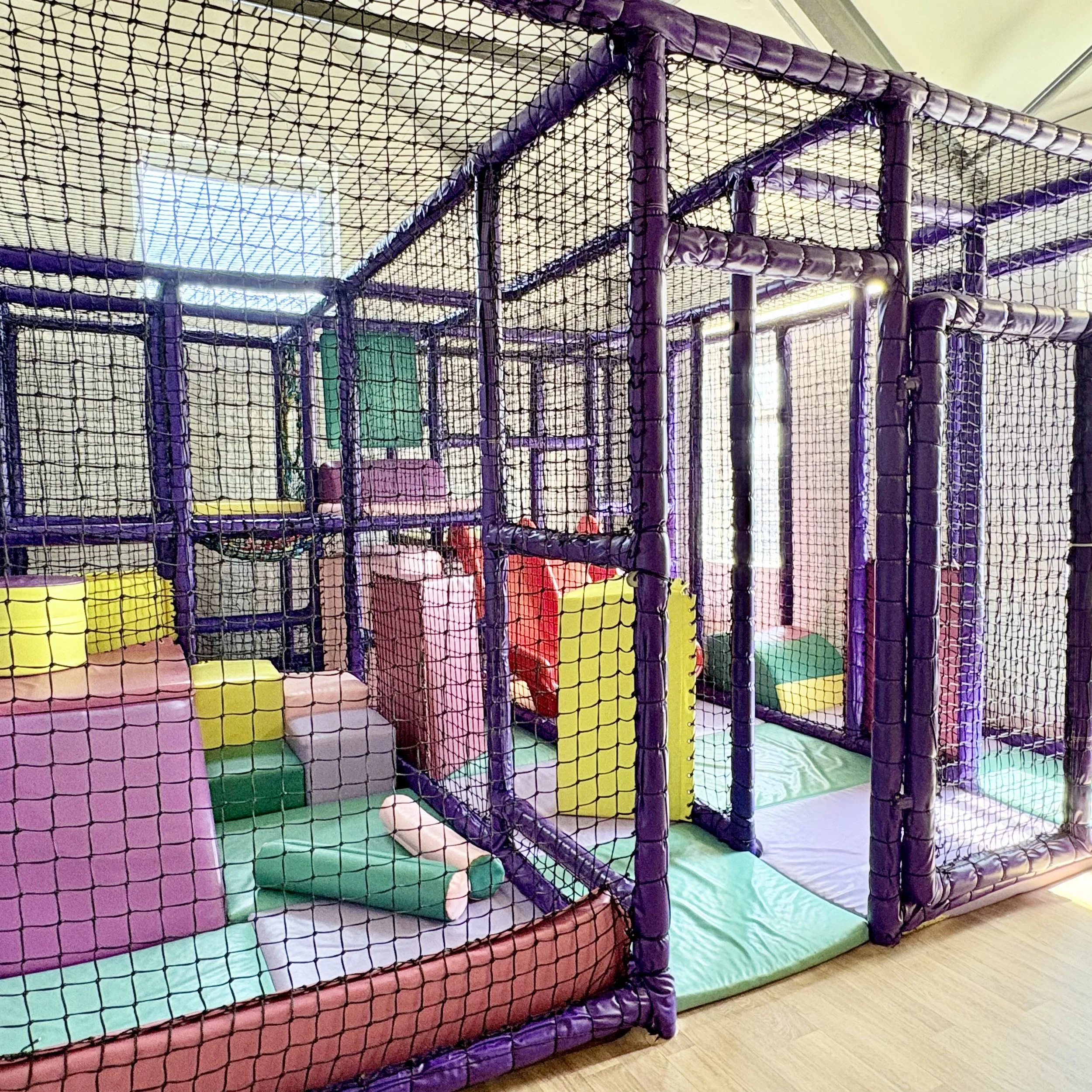 Our small but mighty soft play area with climbing areas and red slide