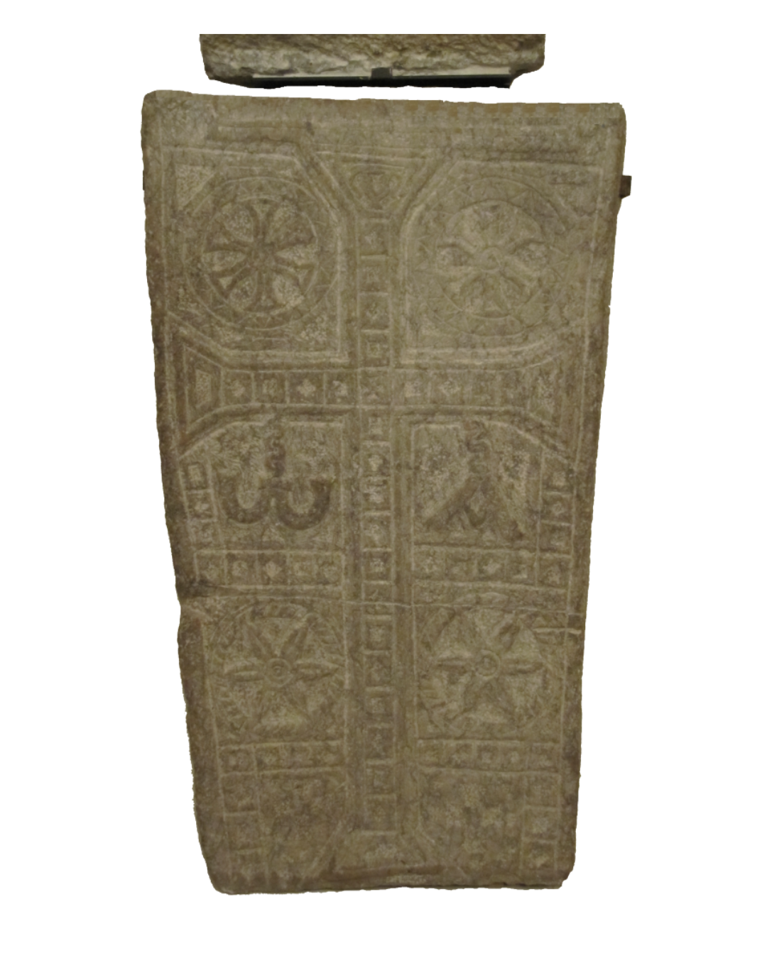 Ancient stone slab with carved Christian symbols and inscriptions, including a cross, fish, and other religious motifs.