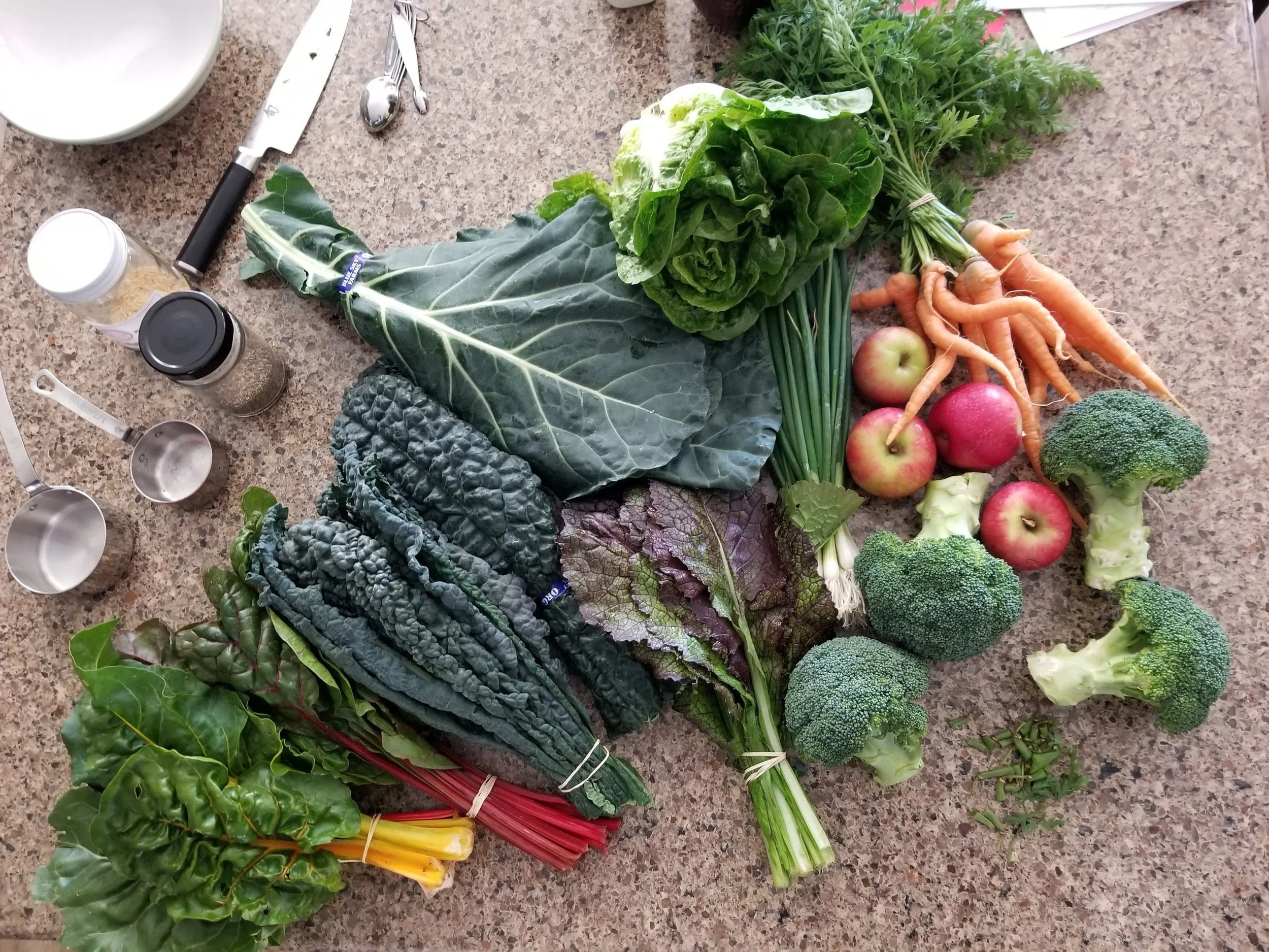 Fresh whole-food, plant-based vegetables and fruit displayed on Jennifer Diamond’s kitchen counter, reflecting her belief in nourishing the body with real food.