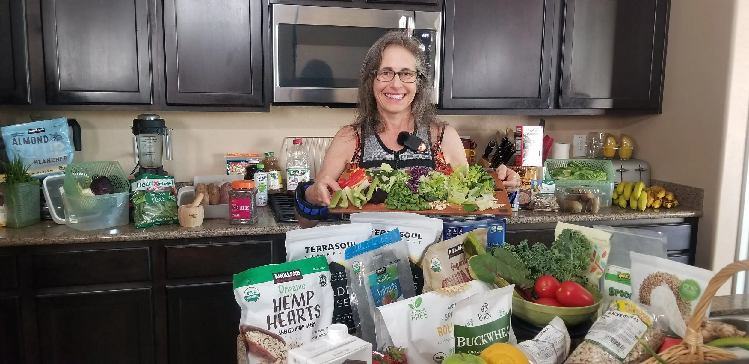 Jennifer Diamond preparing fresh whole-food, plant-based ingredients in her kitchen.