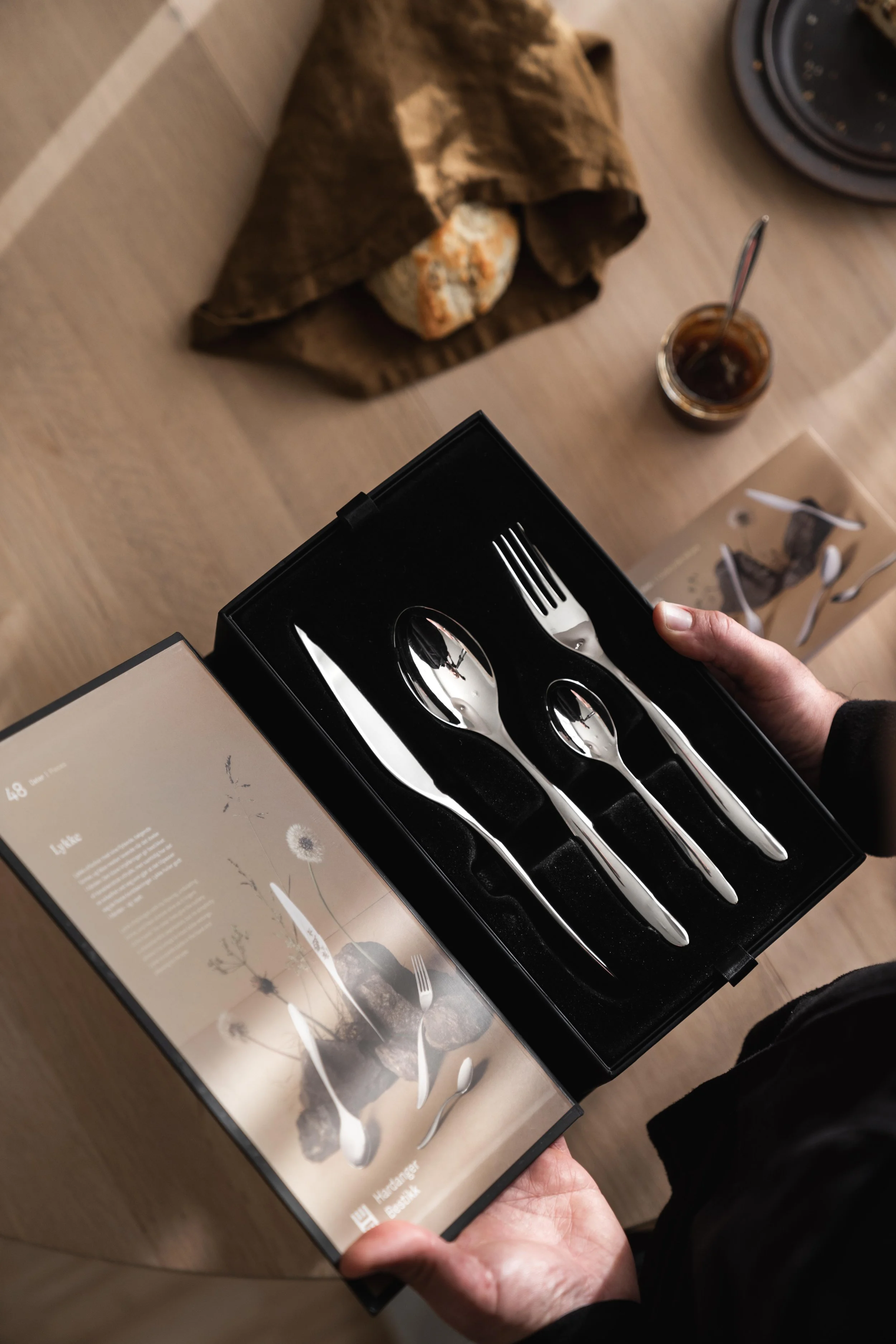 Hardanger Bestikk packaging styled on a kitchen surface, styling by Catrine Svellingen