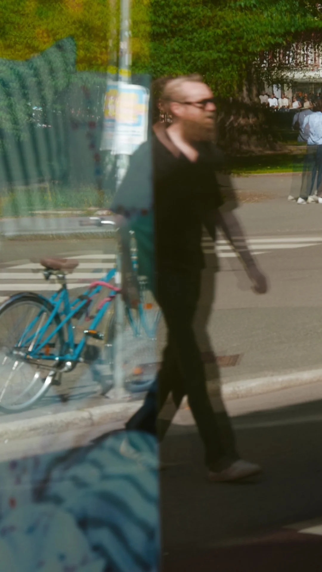 Per Ove Akselvoll wearing HUG Spectacles DUPREE sunglasses, captured in reflection on an Oslo street.