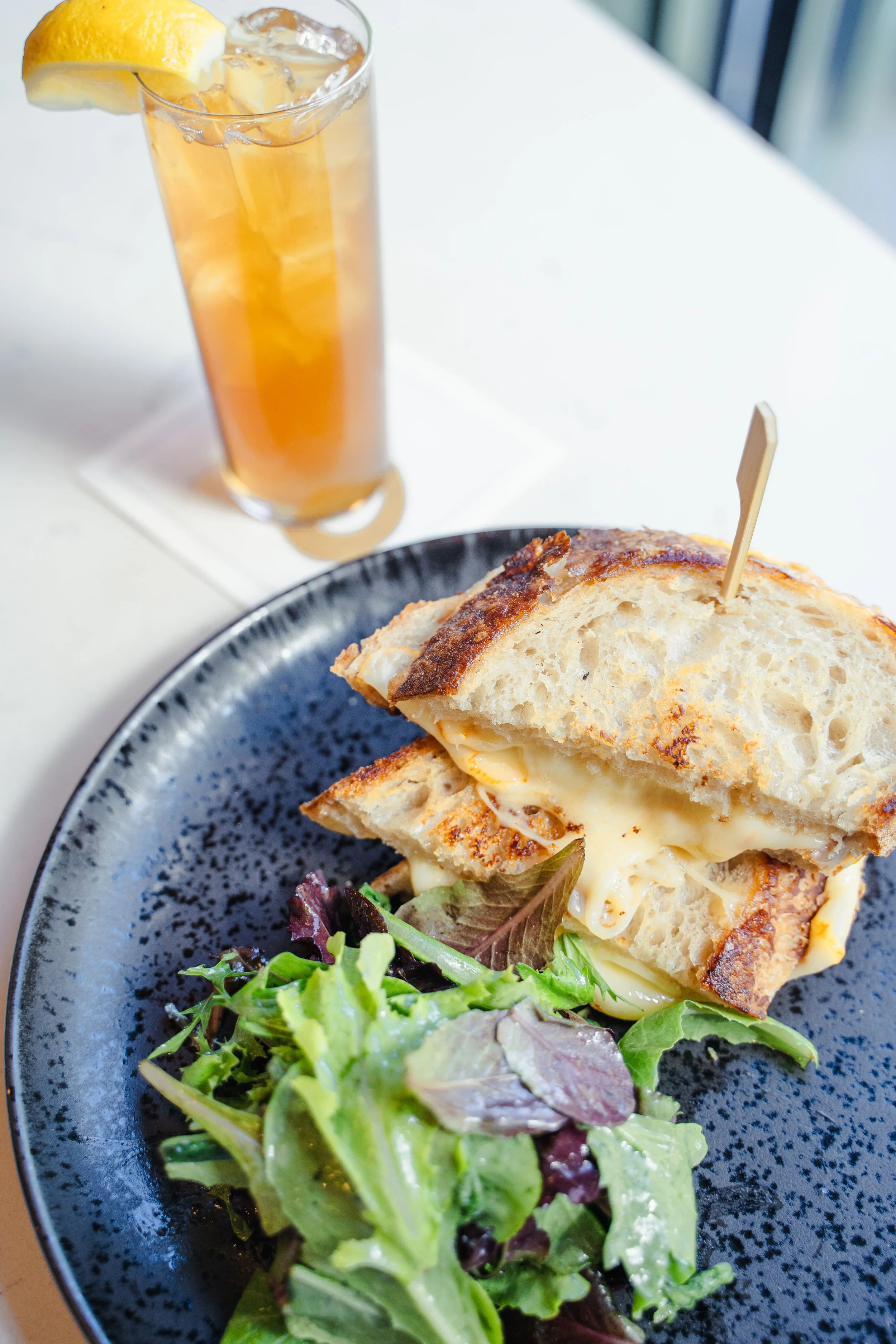 Patio dining in Aspen with grilled cheese, a fresh spring salad, and iced tea for the perfect casual lunch.