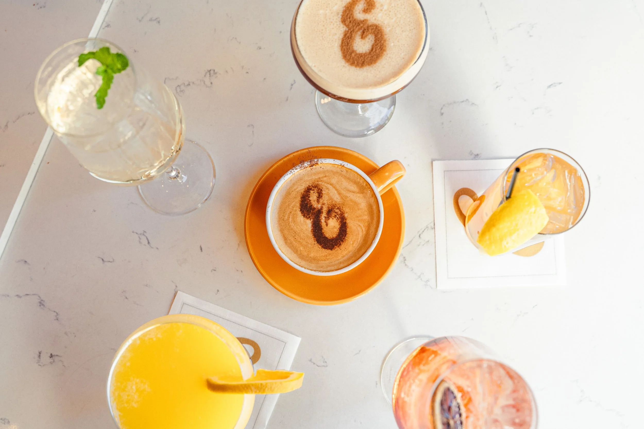 Coffee and cocktails at Eddy’s in Aspen, featuring espresso drinks, lattes, spritzes, and mimosas.