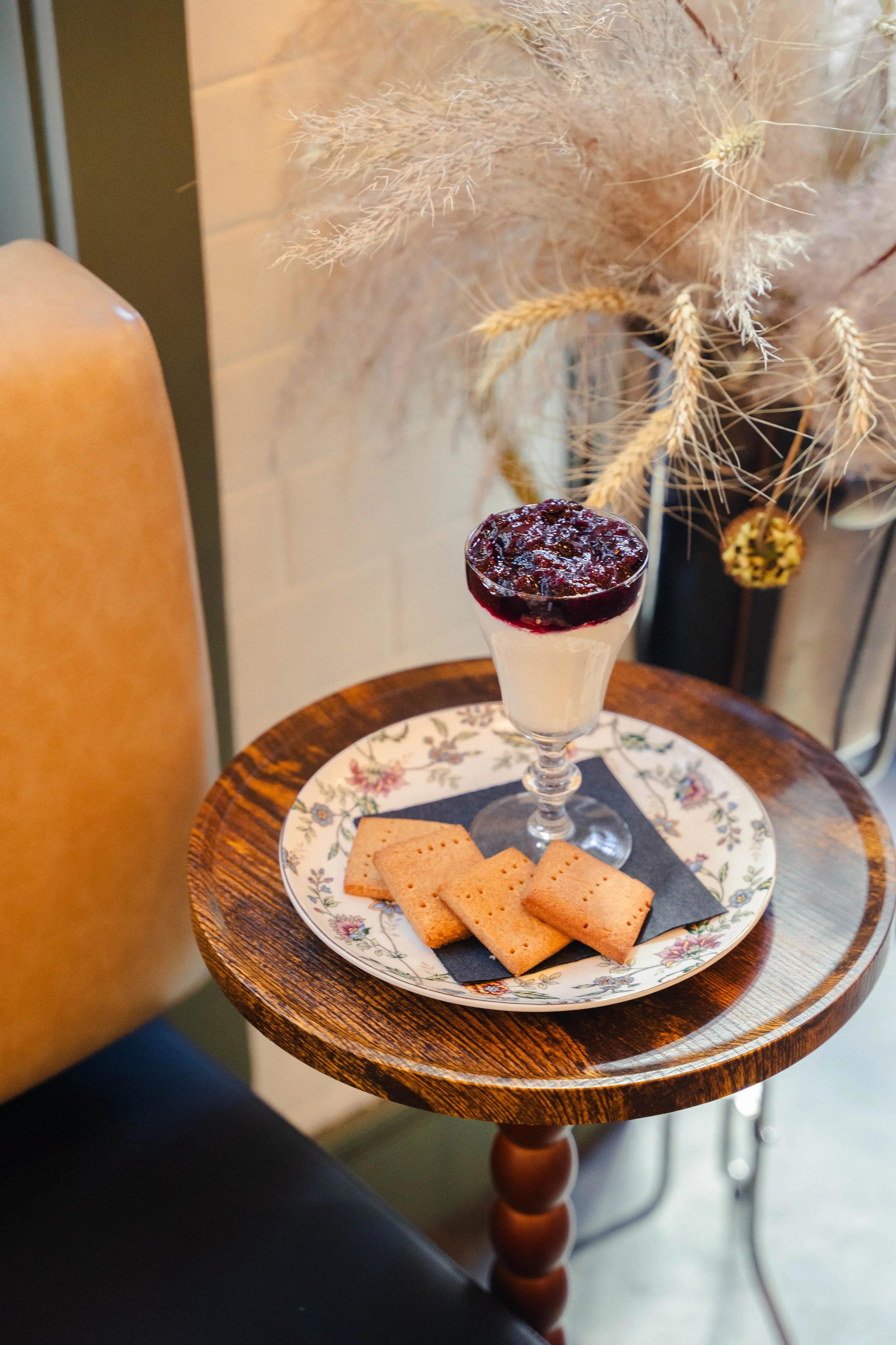 Classic creamy cheesecake topped with housemade blueberry compote and local Roaring Fork Mill graham crackers, elegantly served in a coupe glass at Eddy’s Kitchen in downtown Aspen.