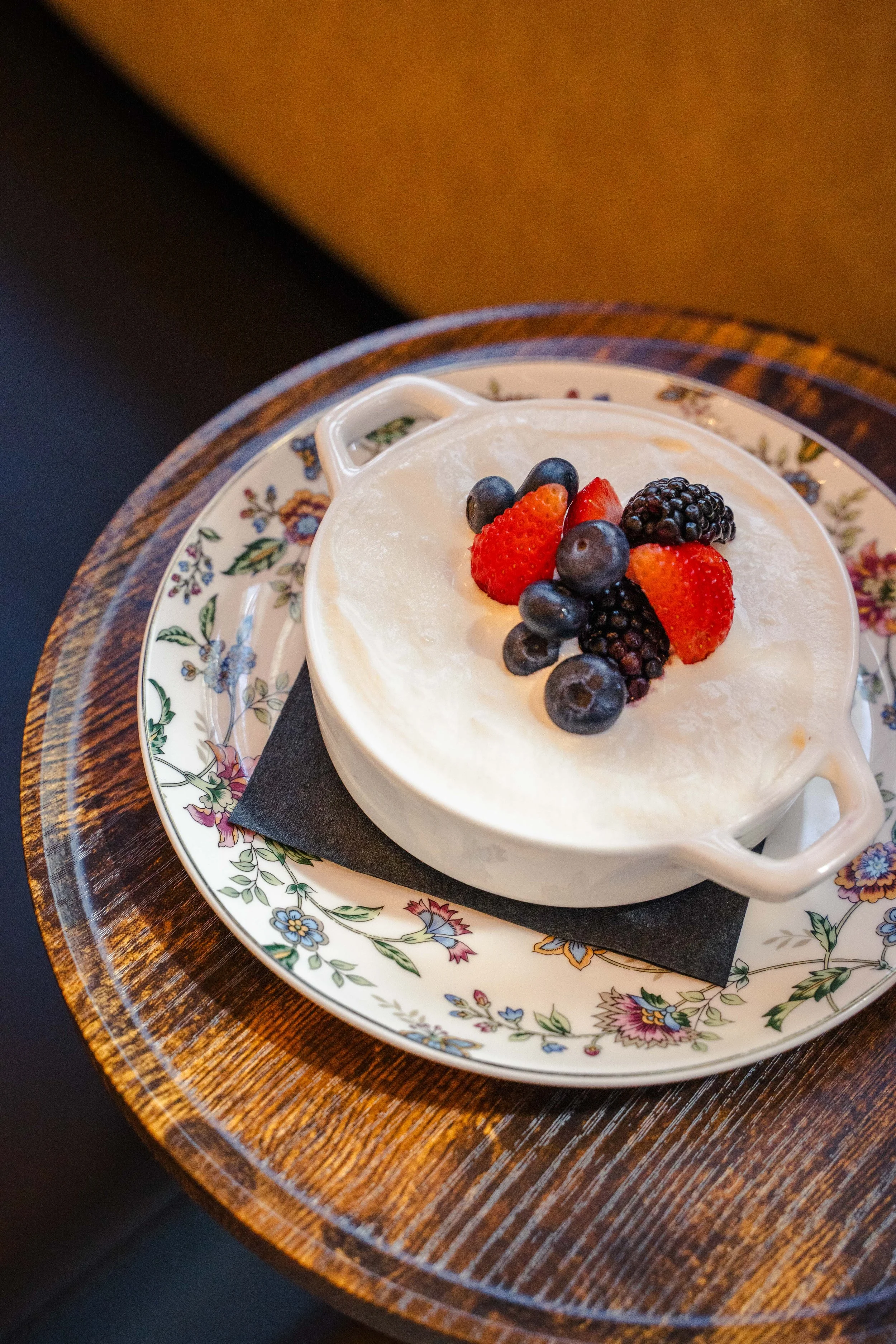 Tres leches cake topped with housemade whipped cream and fresh seasonal fruit, a delicious dessert at Eddy’s Kitchen in downtown Aspen.