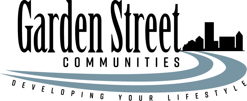 A stylized logo with curved lines in shades of blue, resembling a swoosh or waves.