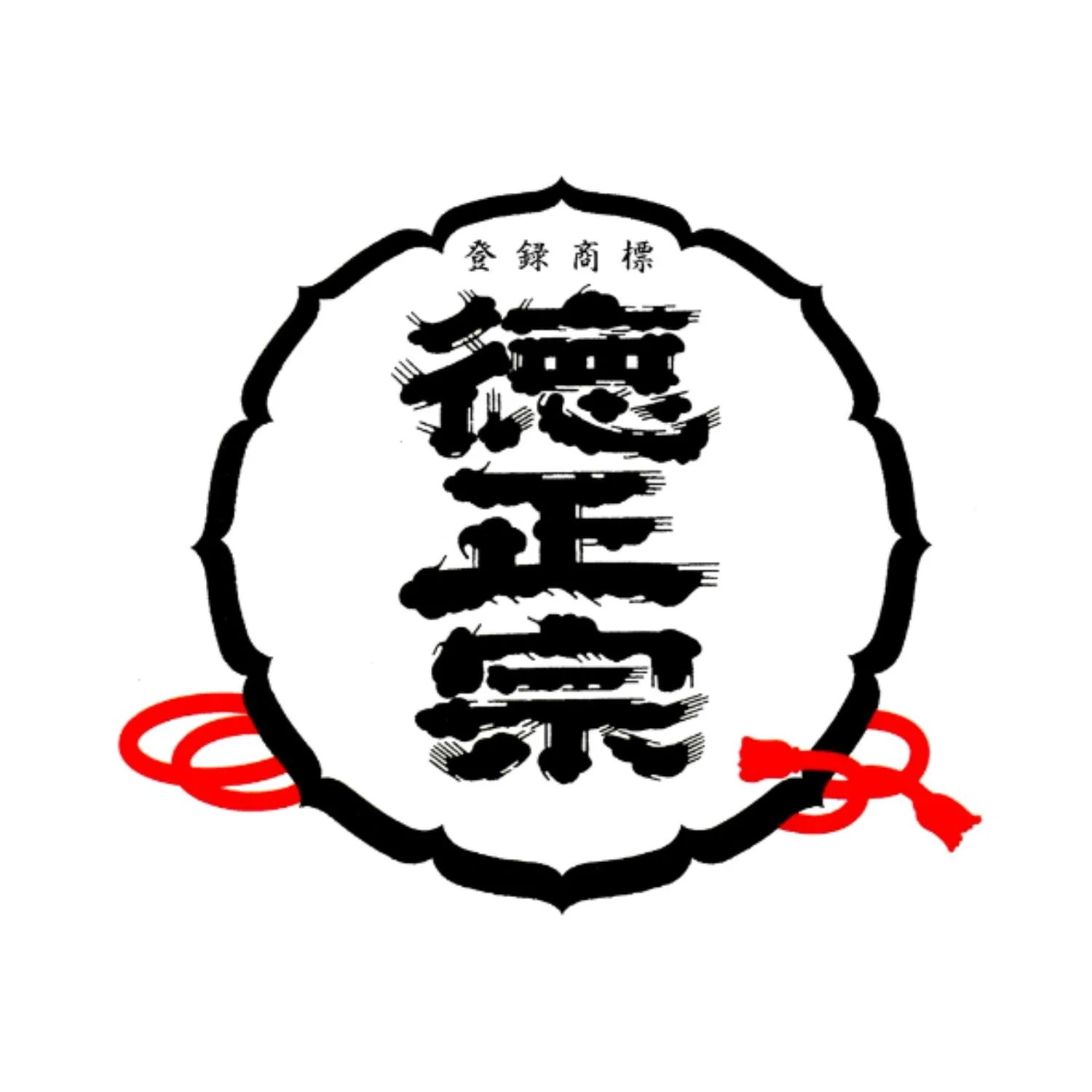 A traditional Japanese sword guard with Japanese characters and red decorative cords.