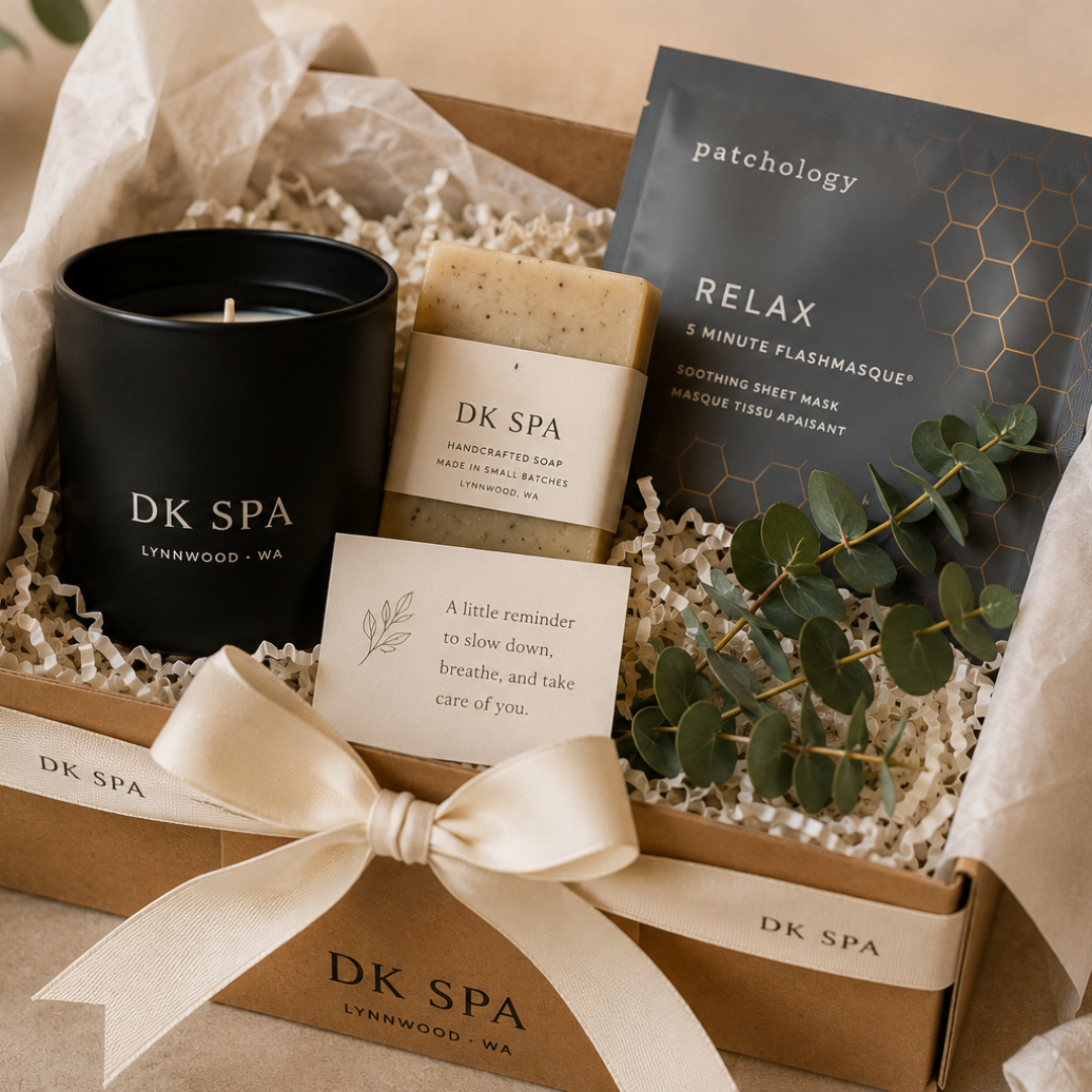 Beautifully wrapped DK Spa self-care gift box featuring a candle, handmade soap, Patchology face mask, and eucalyptus.