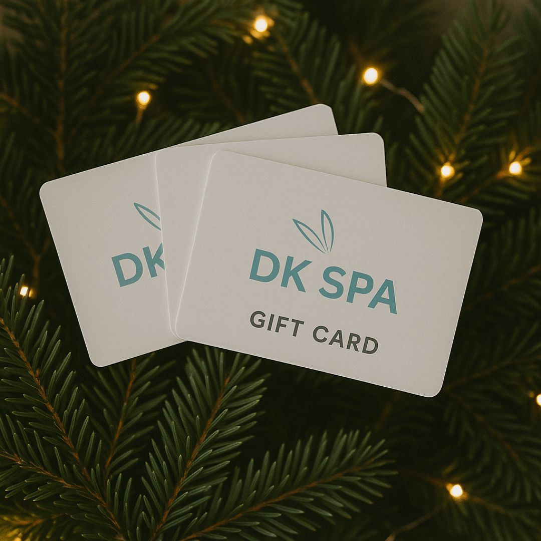 DK Spa gift cards surrounded by holiday greenery.