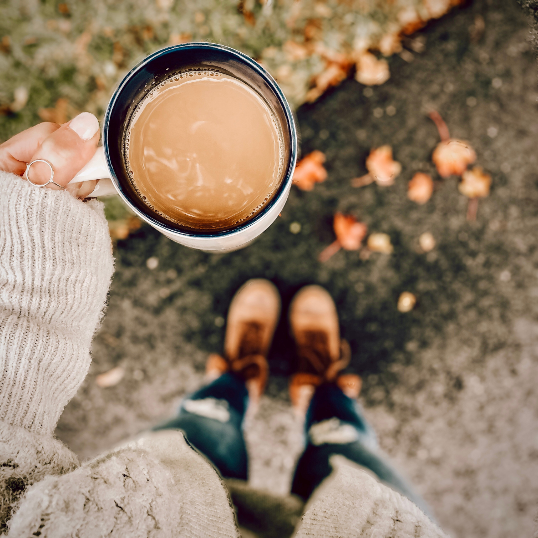Moisturizer and serum arranged with soft towels and autumn leaves for a fall skincare routine.