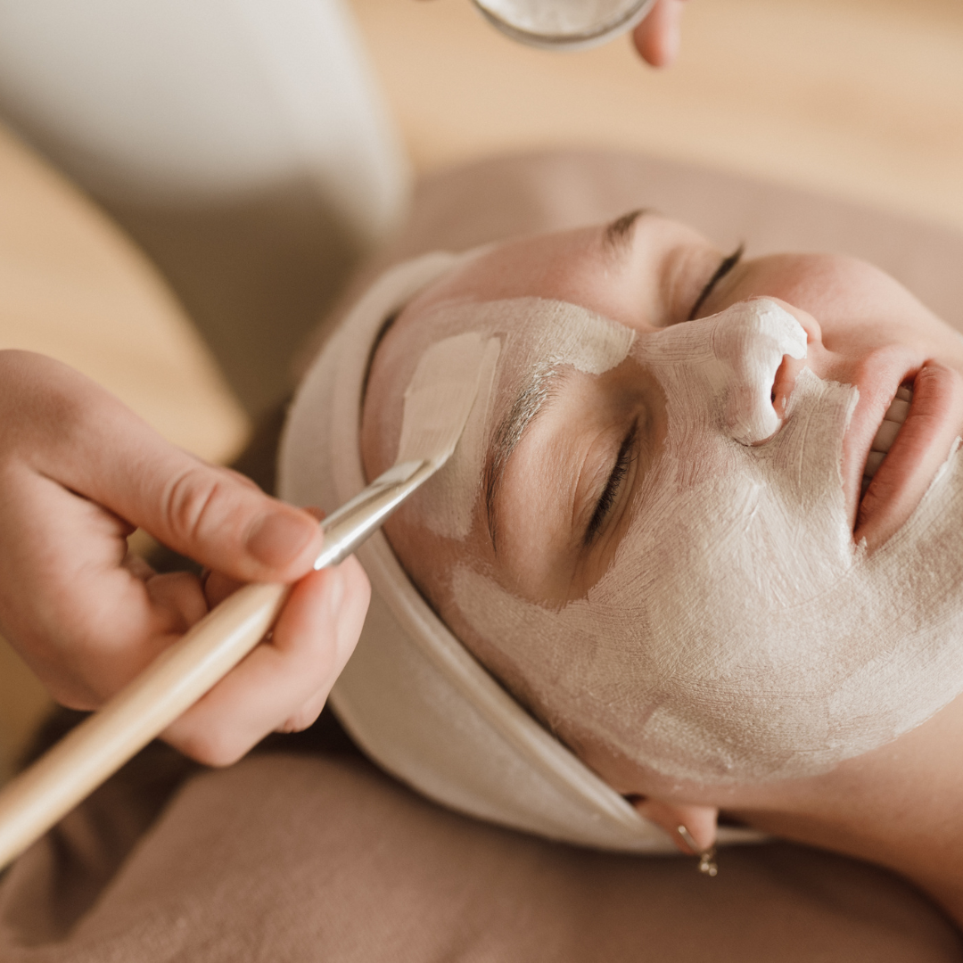 Client receiving a professional facial mask treatment at DK Spa