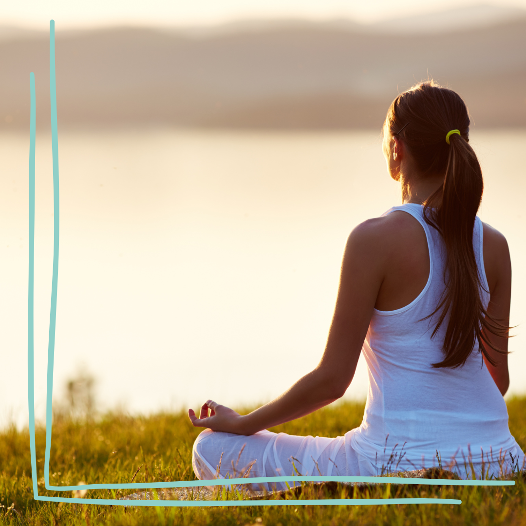 Woman meditating outdoors at sunset as part of a calming wellness routine