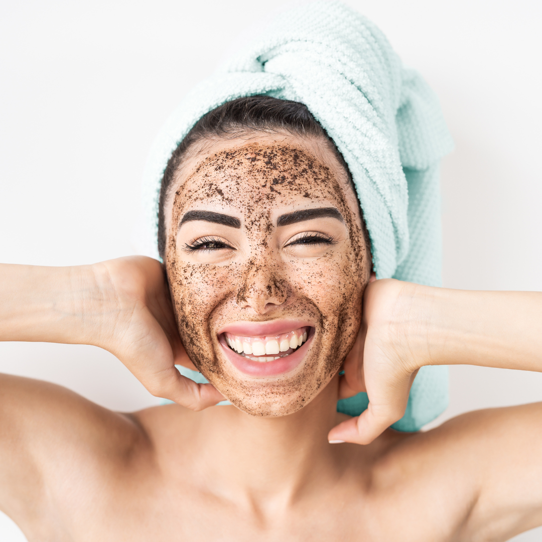 Woman smiling while wearing an exfoliating facial treatment