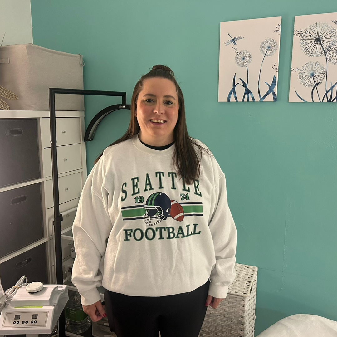 Dana at DK Spa wearing Seattle football gear for 12th Fridays