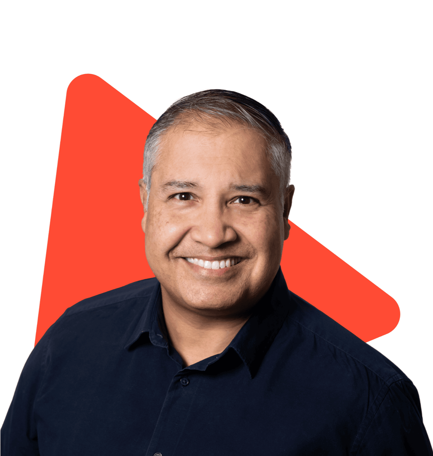 Portrait of a smiling man with gray hair in front of a white background with a large red geometric shape.