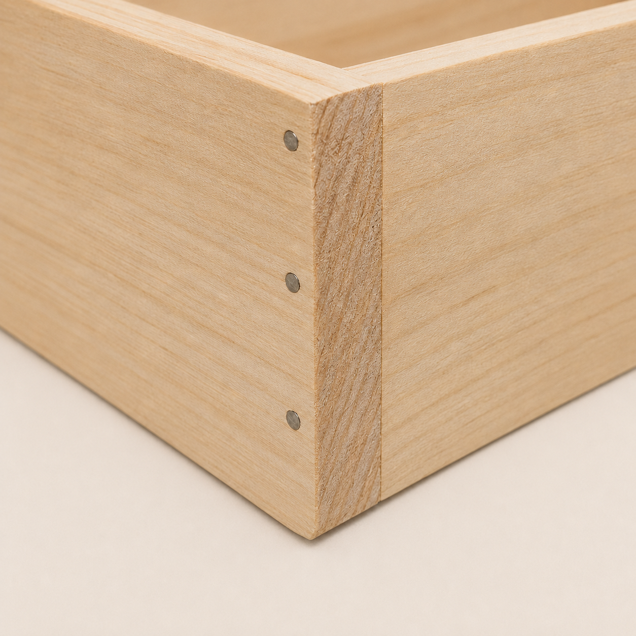 Nail-and-glue corner construction on a wooden wine box.