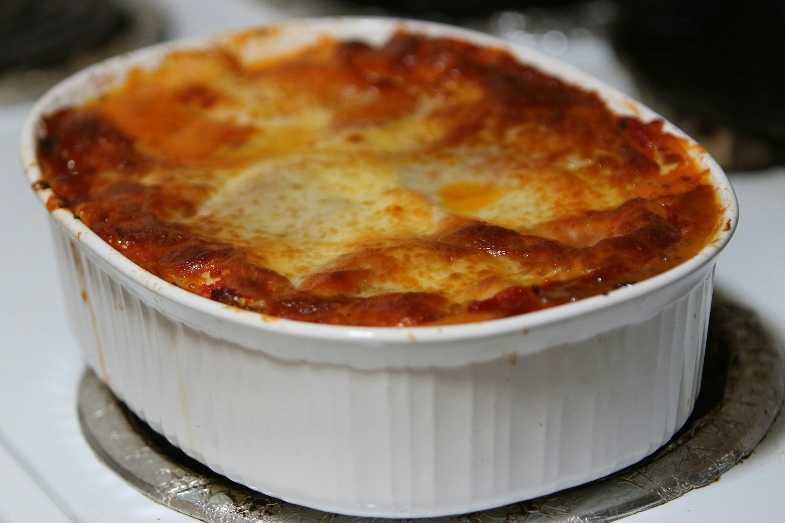 aunt toni's signature eggplant parmesan in casserole dish