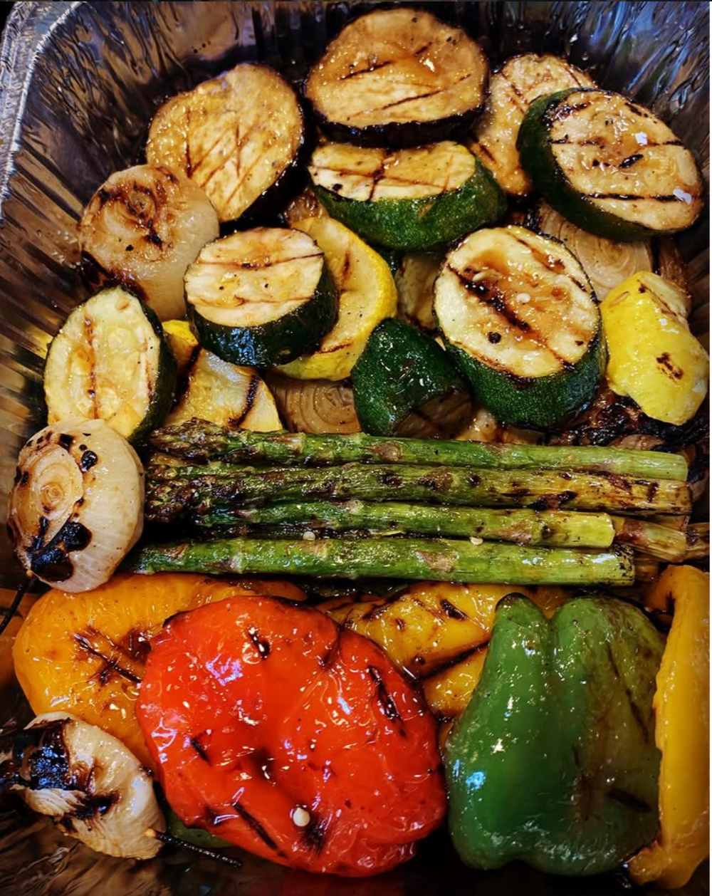 Grilled mixed vegetables including zucchini, yellow squash, red and green bell peppers, cherry tomato, onion, garlic, and asparagus