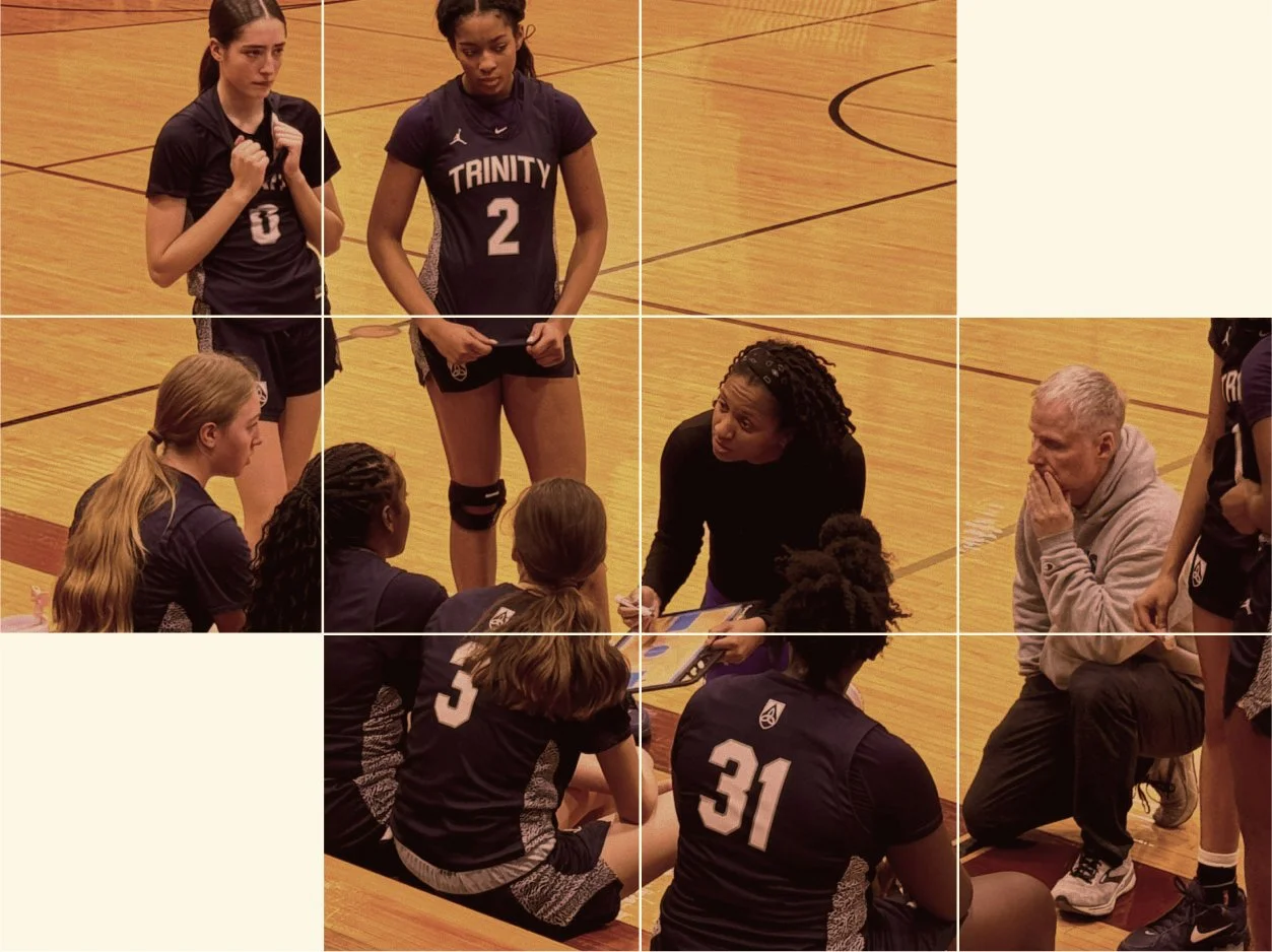 Girls' basketball team huddle during a game, with coach giving instructions on the court.