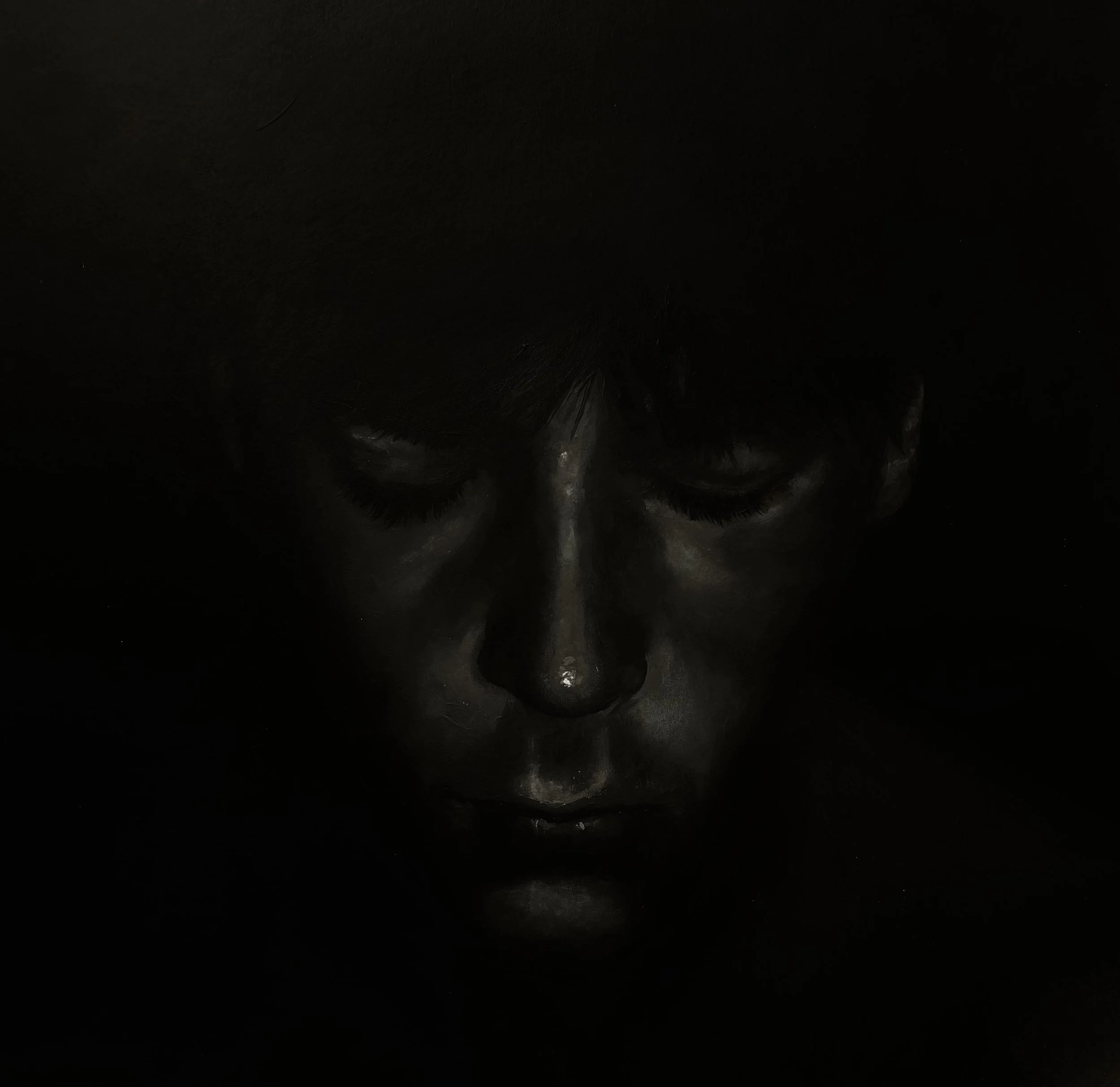 Dark image with a faint outline of a person's head, beard and glasses, and a shadowy background.