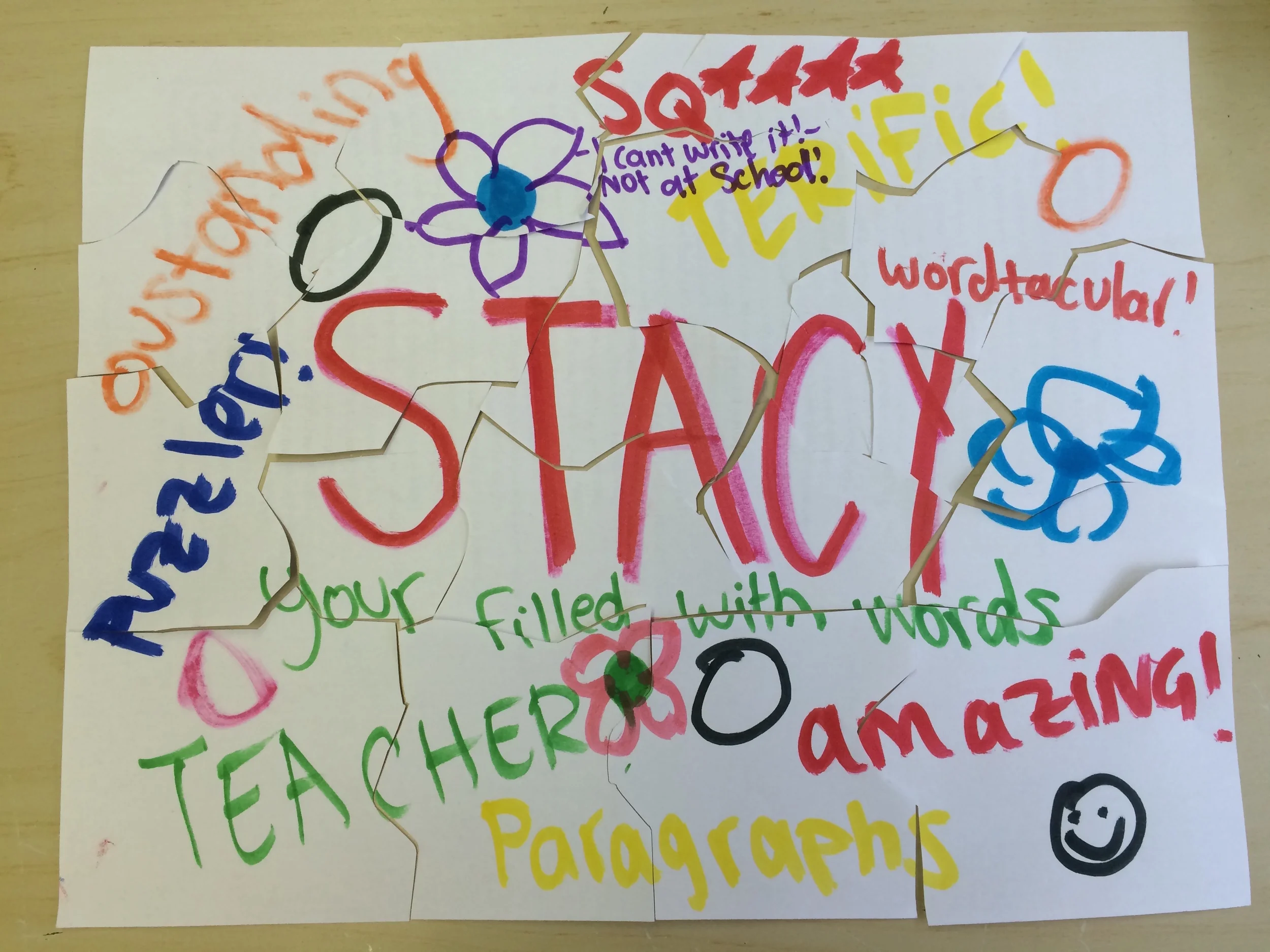 Colorful handwritten notes on torn pieces of paper, including words like 'story,' 'interesting,' 'wonderful,' 'filled with words,' and other positive comments, with drawings of flowers and smiley faces.