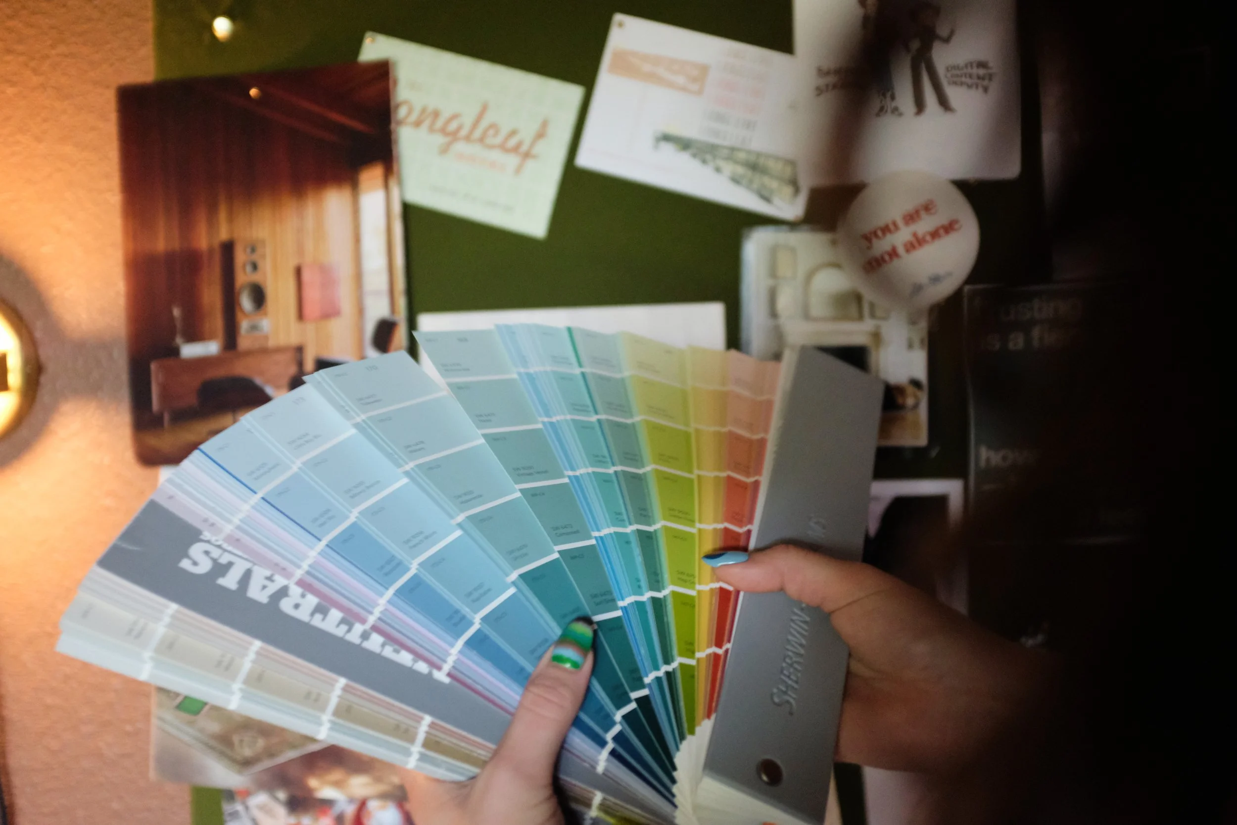close up of paint swatches held by interior decorator
