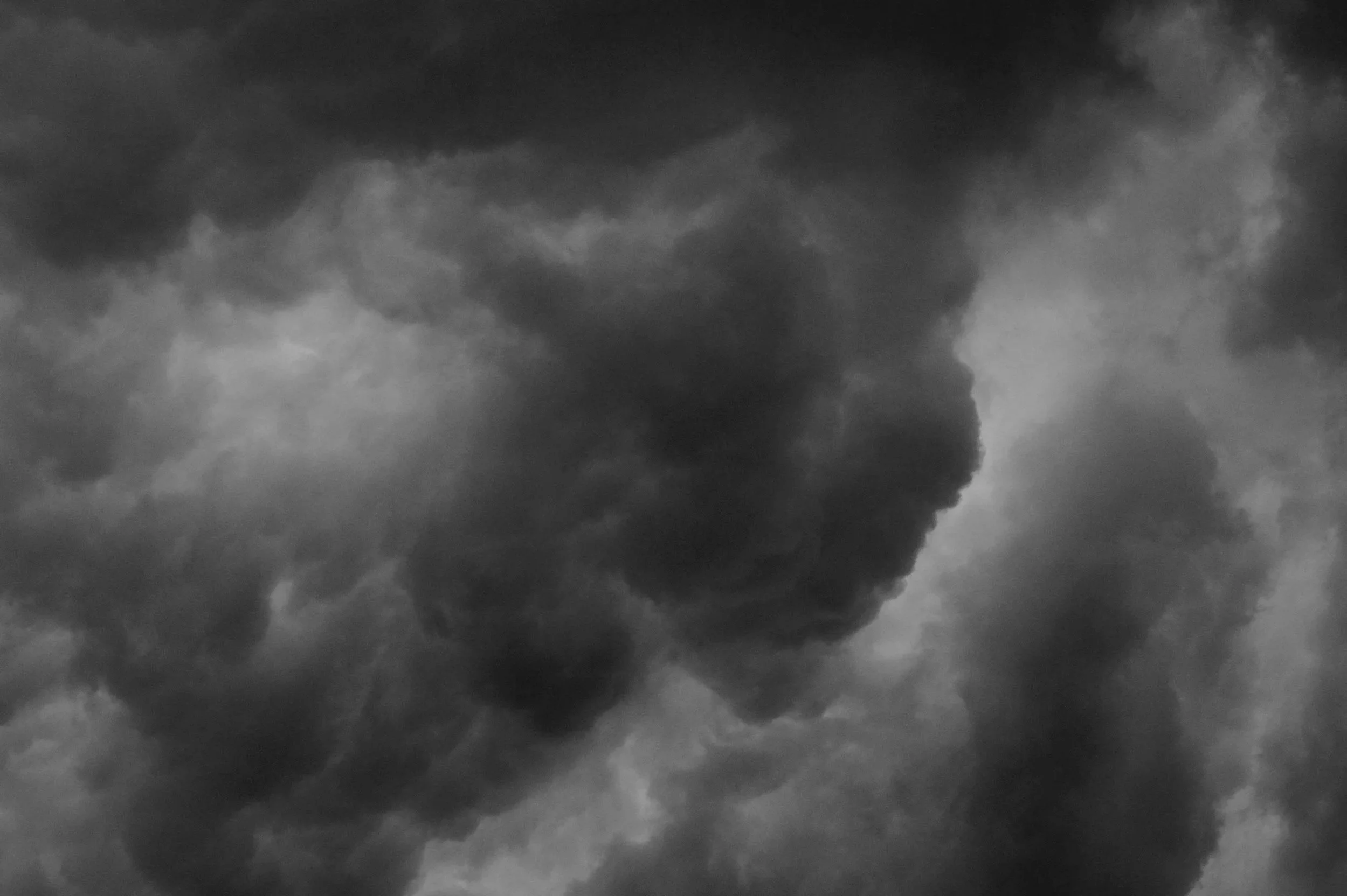 Dark and stormy clouds filling the sky, with varying shades of gray indicating an impending storm.