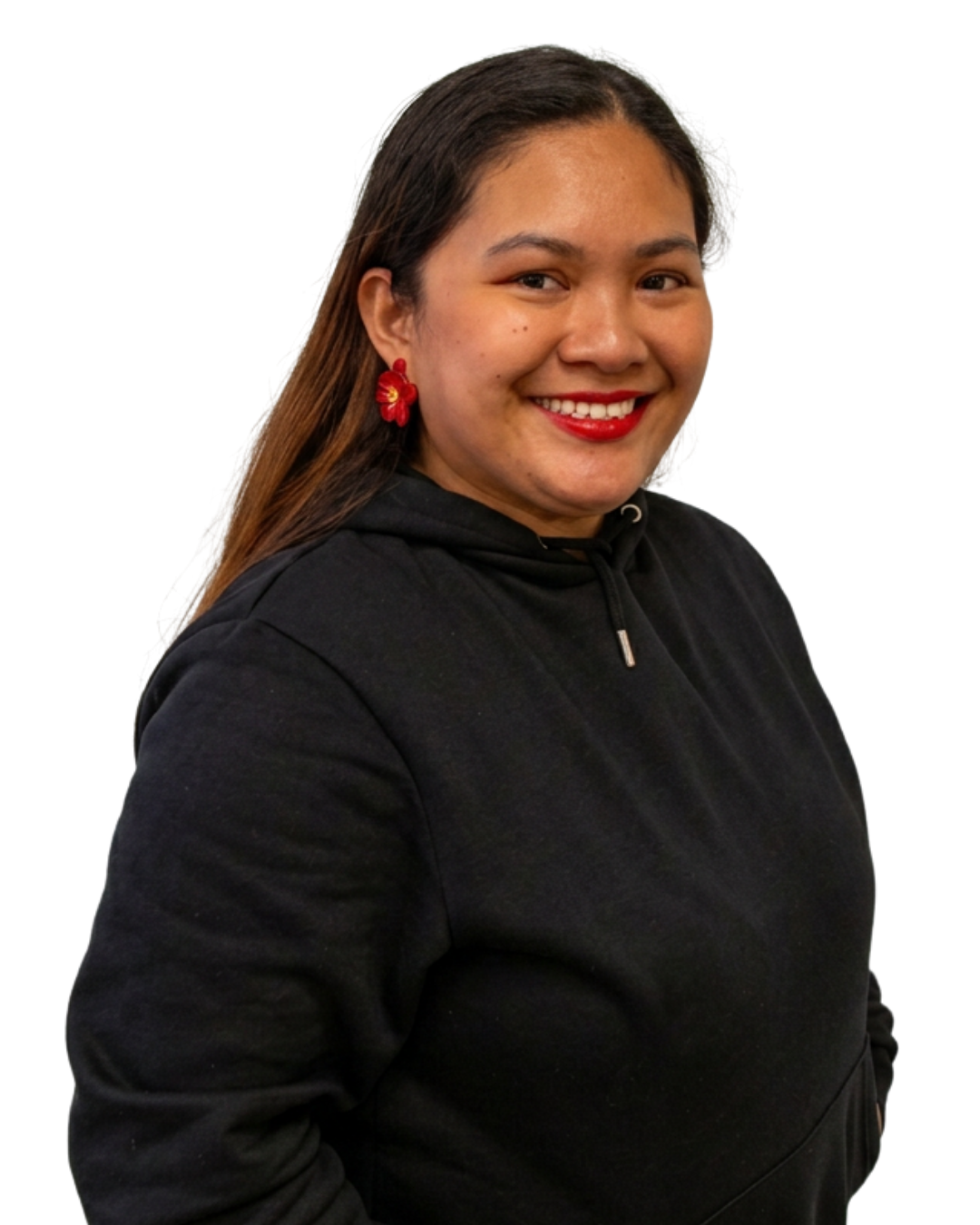 A woman with long brown hair smiling, wearing a black hoodie and red flower earrings.