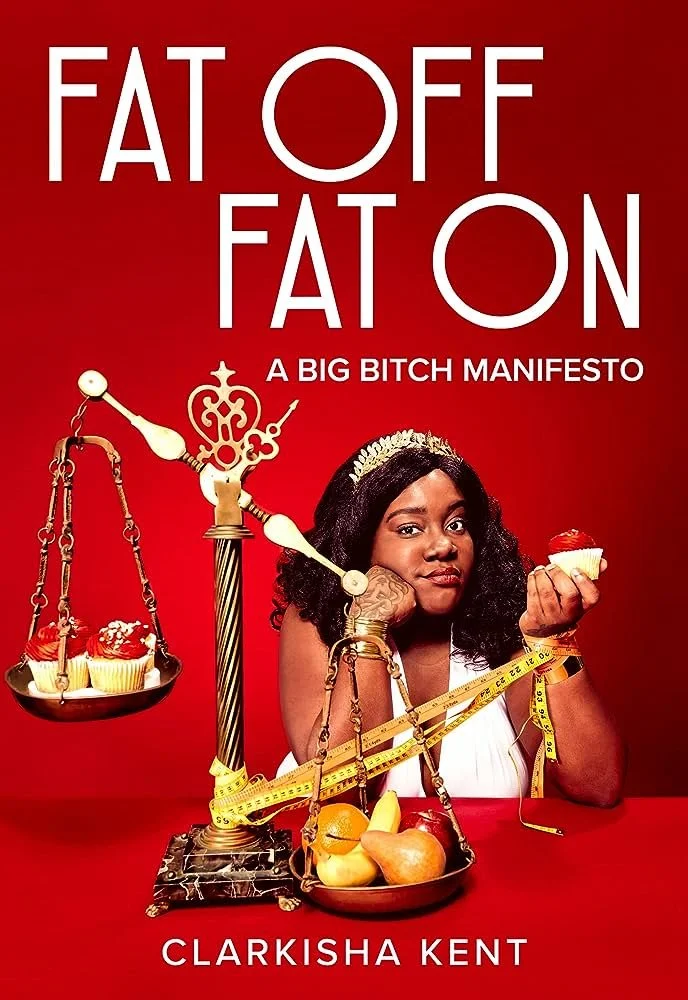 Book cover titled "FAT OFF FAT ON: A BIG BITCH MANIFESTO" by Clarkisha Kent. The cover shows a woman with dark curly hair, wearing a tiara, holding a cupcake, with a balanced scale measuring cupcakes and fruits, wrapped with a measuring tape, against a red background.