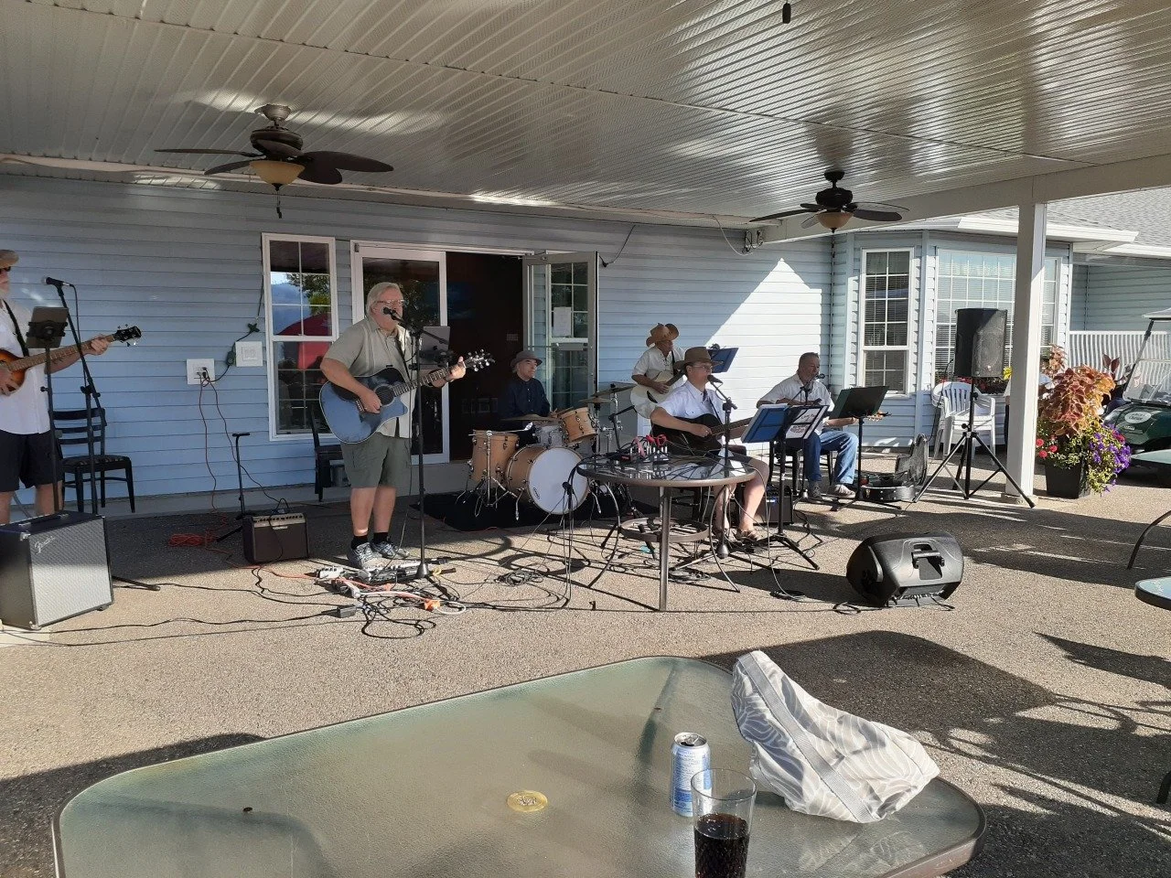 A band playing music under cover at Swan Lake RV Resort clubhouse.