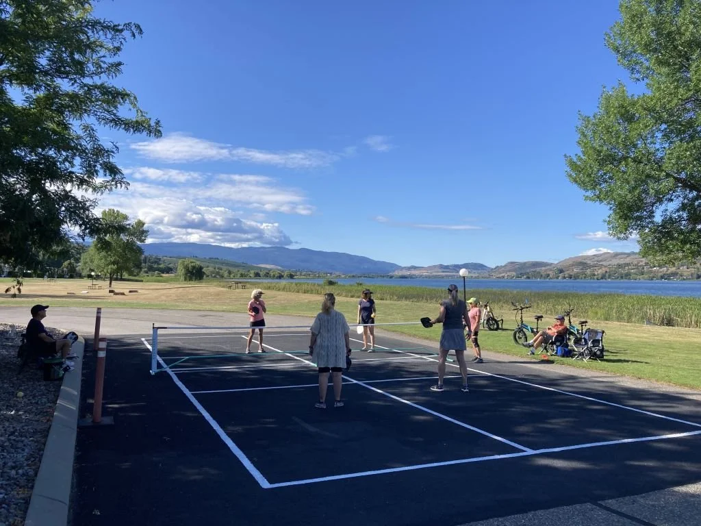 People playing pickleball on an outdoor court at Swan Lake RV Resort.