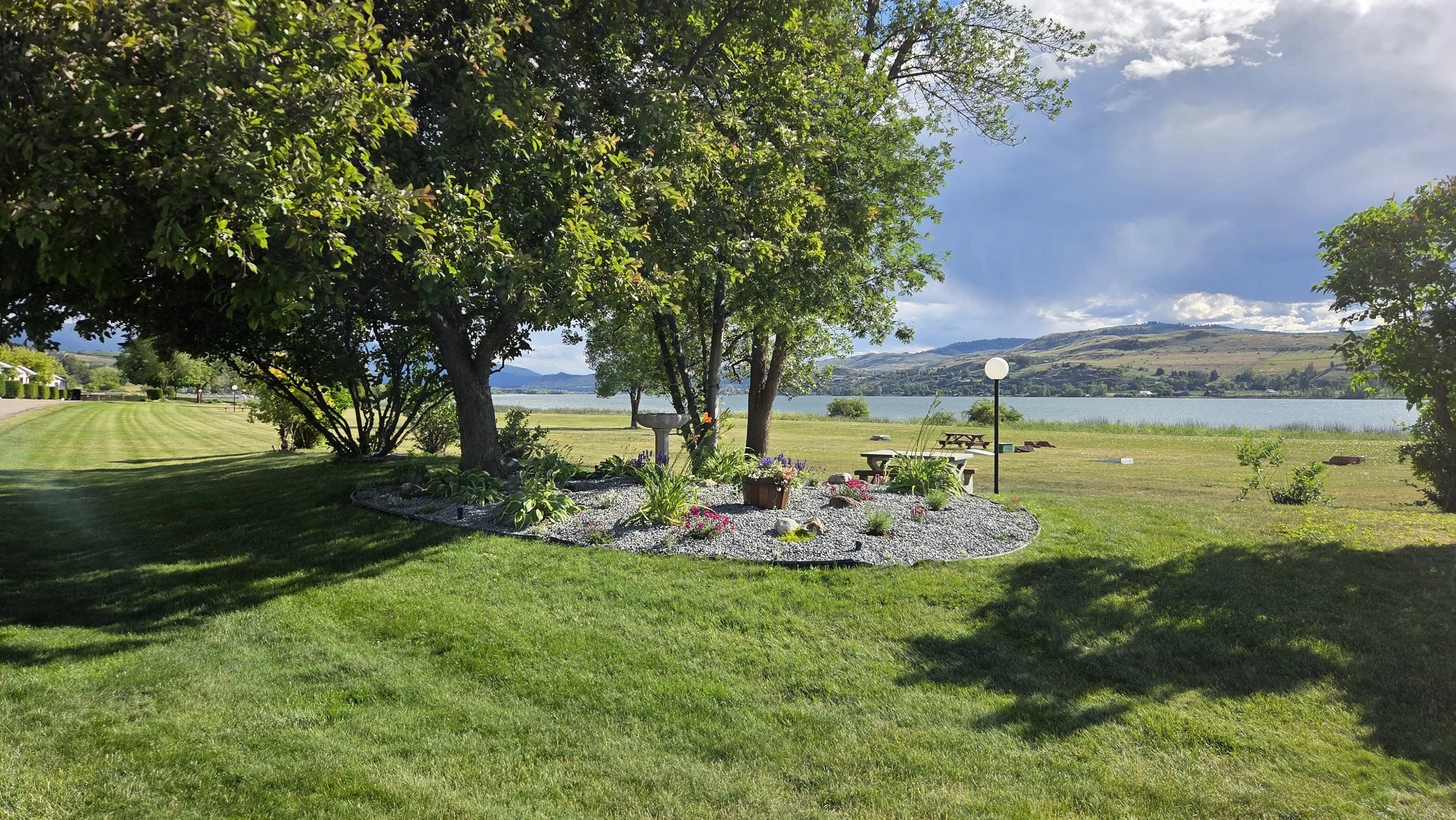 View of Swan Lake RV Resort lakeside lawn.