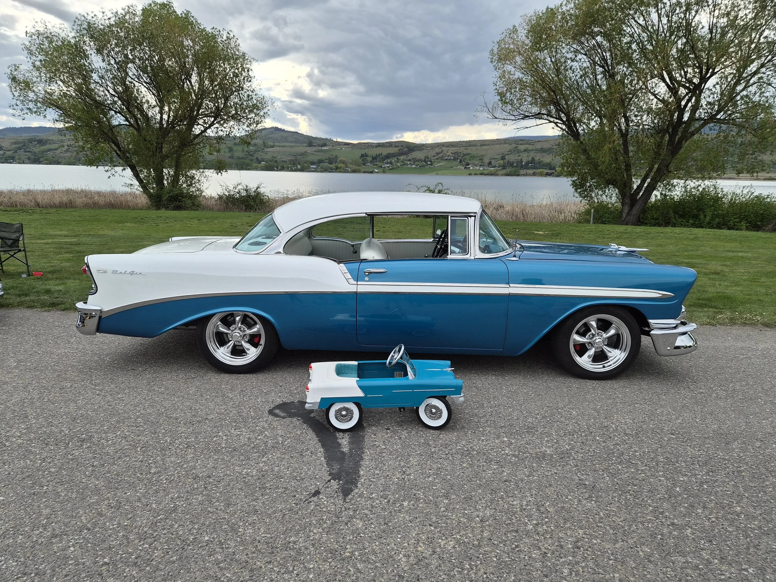 A 1956 blue and white Chevrolet Bel Air car at the Swan Lake RV Resort car show. A small toy "look alike" is in front.
