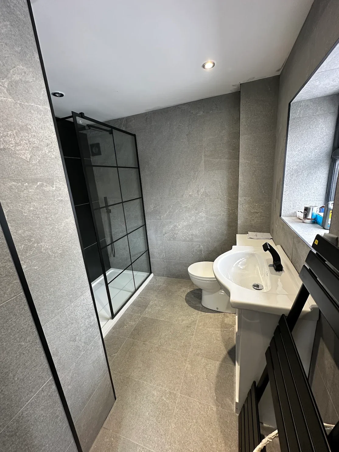 New fully tiled downstairs shower room with black-framed walk-in shower